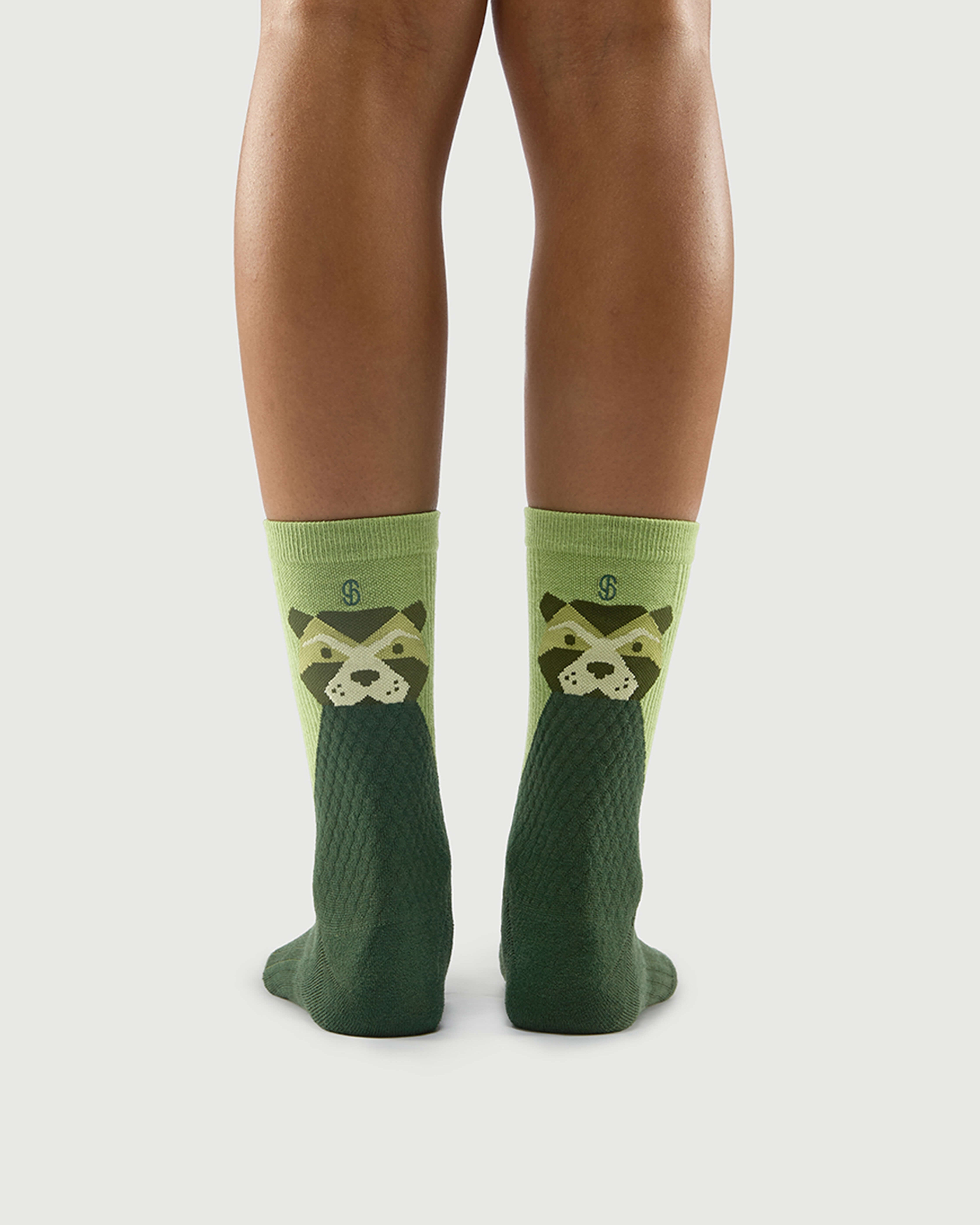 Back view of green Crafty Otter socks on a model, showcasing the otter character design.