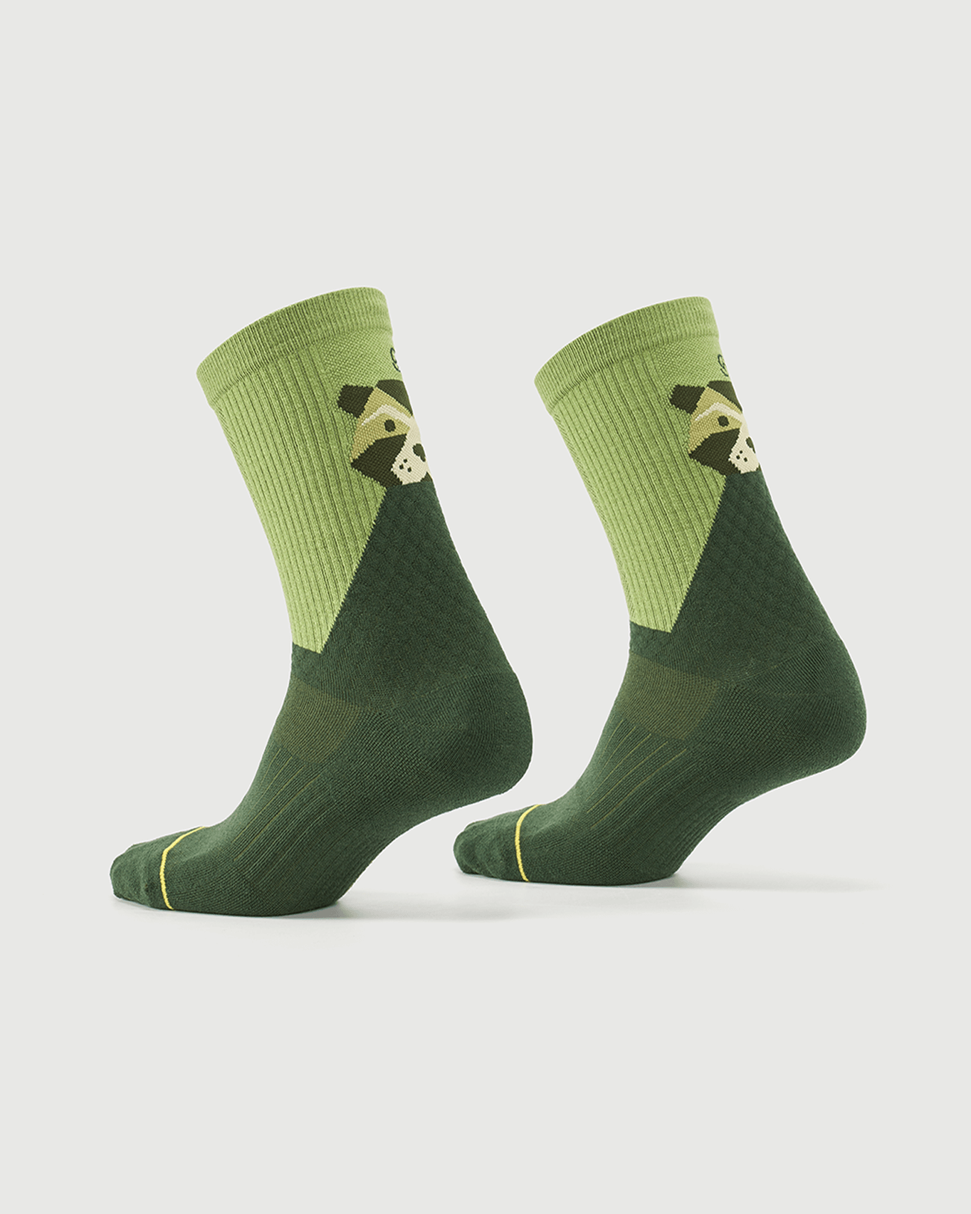 Green Crafty Otter socks on a foot form, showcasing the side profile and otter pattern.