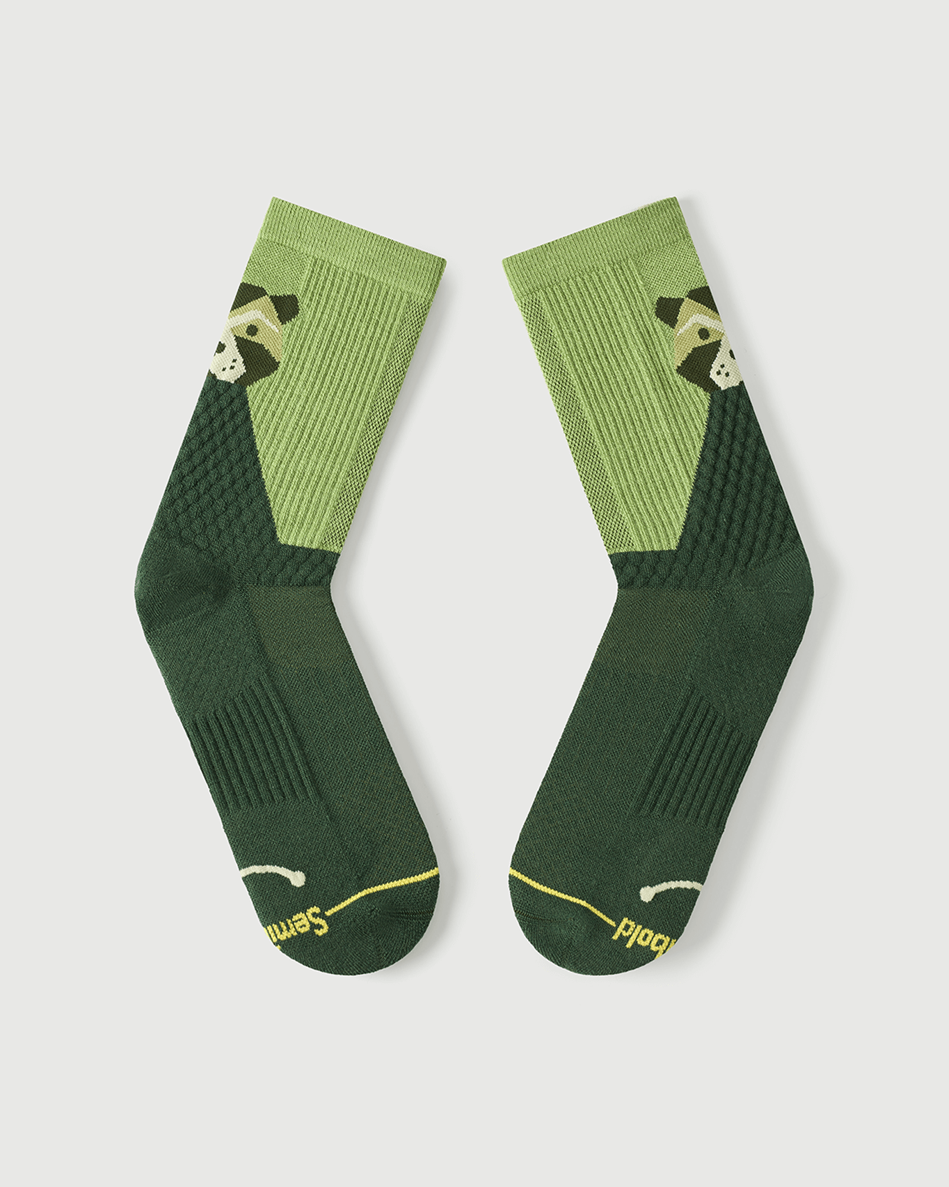 Flat lay view of the lateral side of Crafty Otter green Merino wool hiking socks.