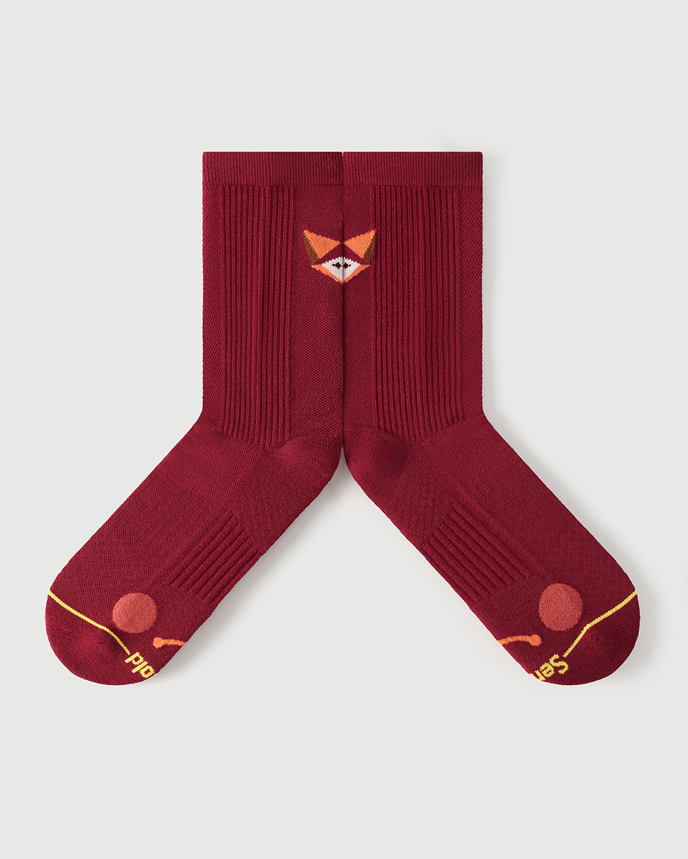 Detailed flat lay of red Devoted Fox socks highlighting the inner arch spine and compression zones.