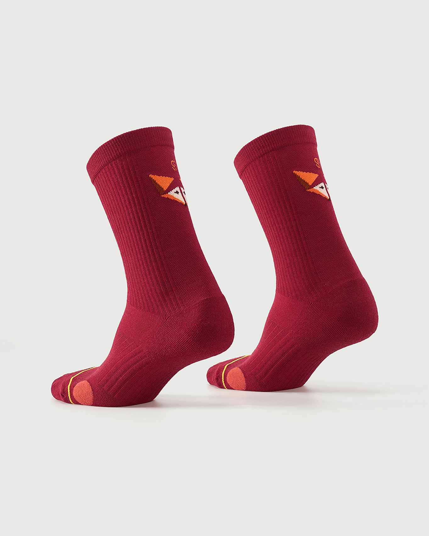Red Devoted Fox socks on a foot form, highlighting the fox character and side construction.