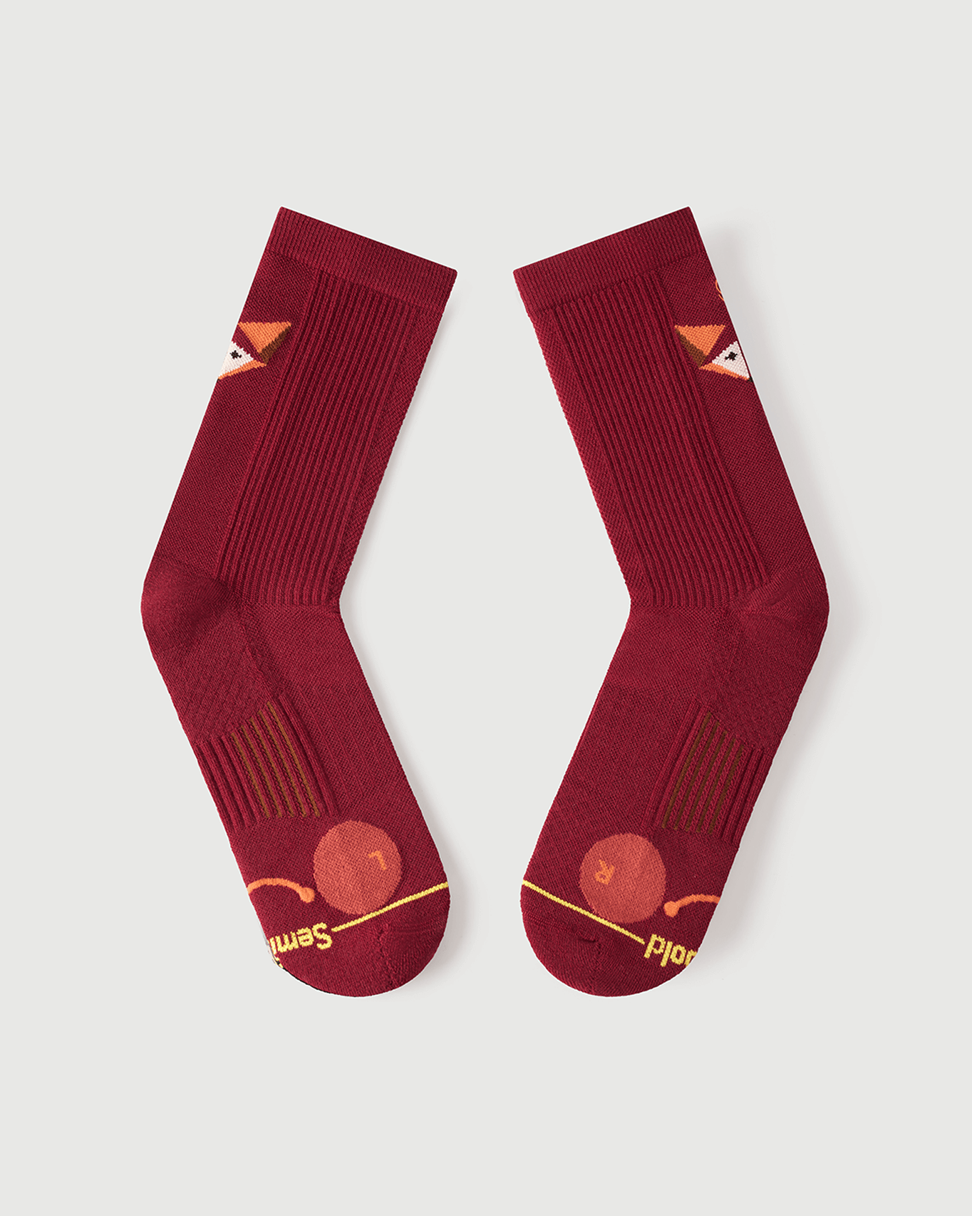 Flat lay of the lateral side of red Devoted Fox socks, showing the outer toe cushion detail.