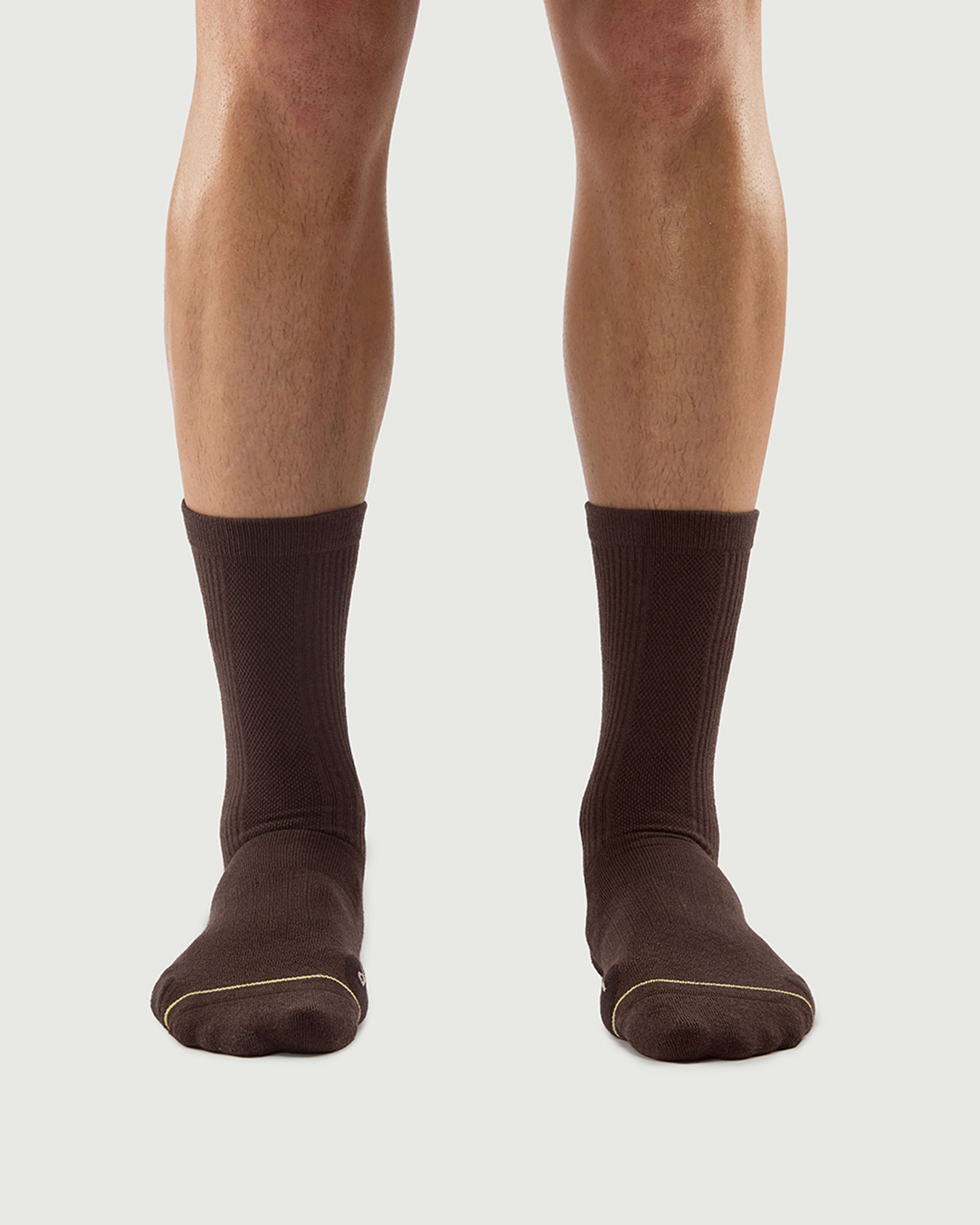 Front view of a model wearing brown Humble Bear Merino wool socks with a comfortable ribbed design.