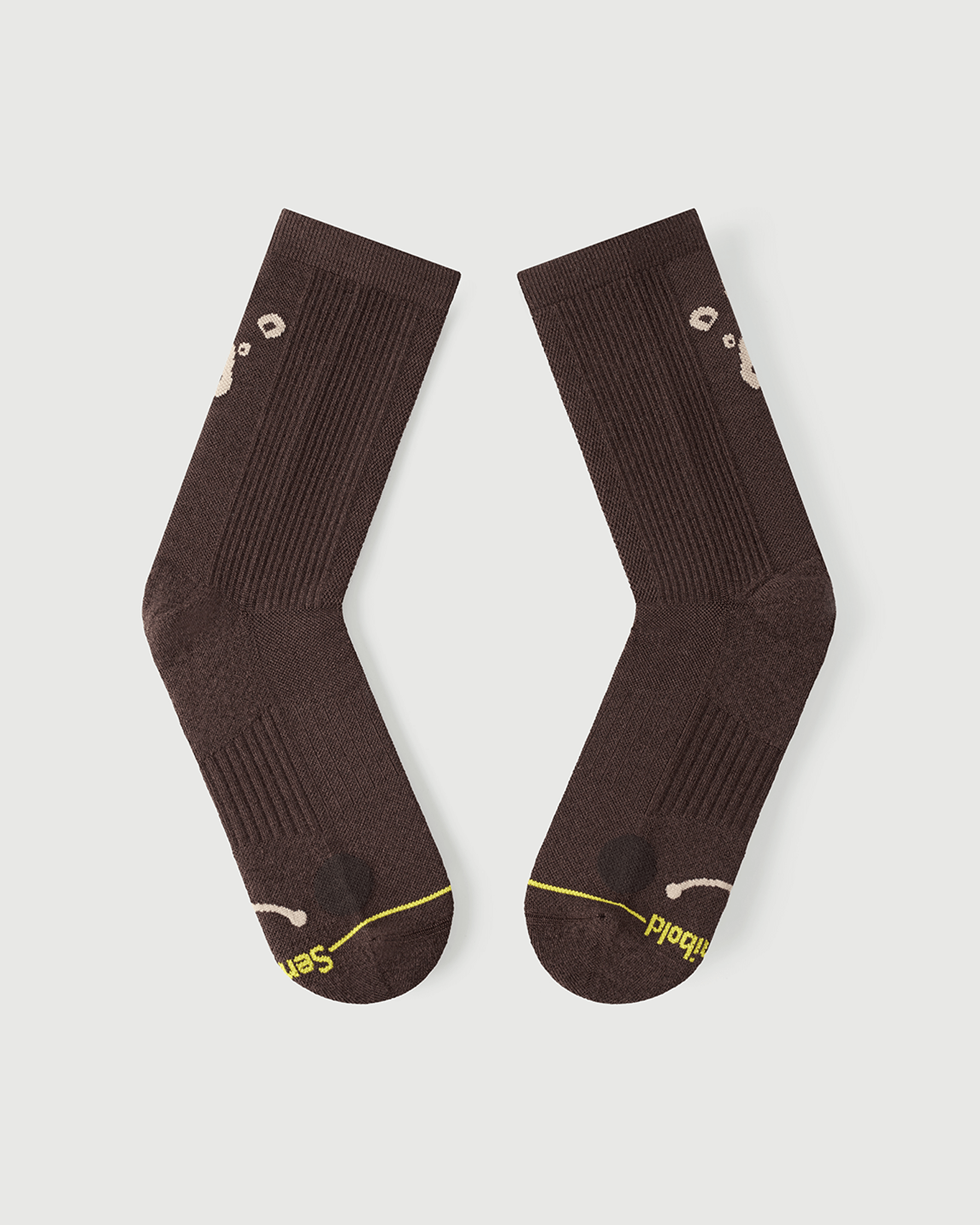 Flat lay view of the lateral side of brown Humble Bear Merino wool socks.