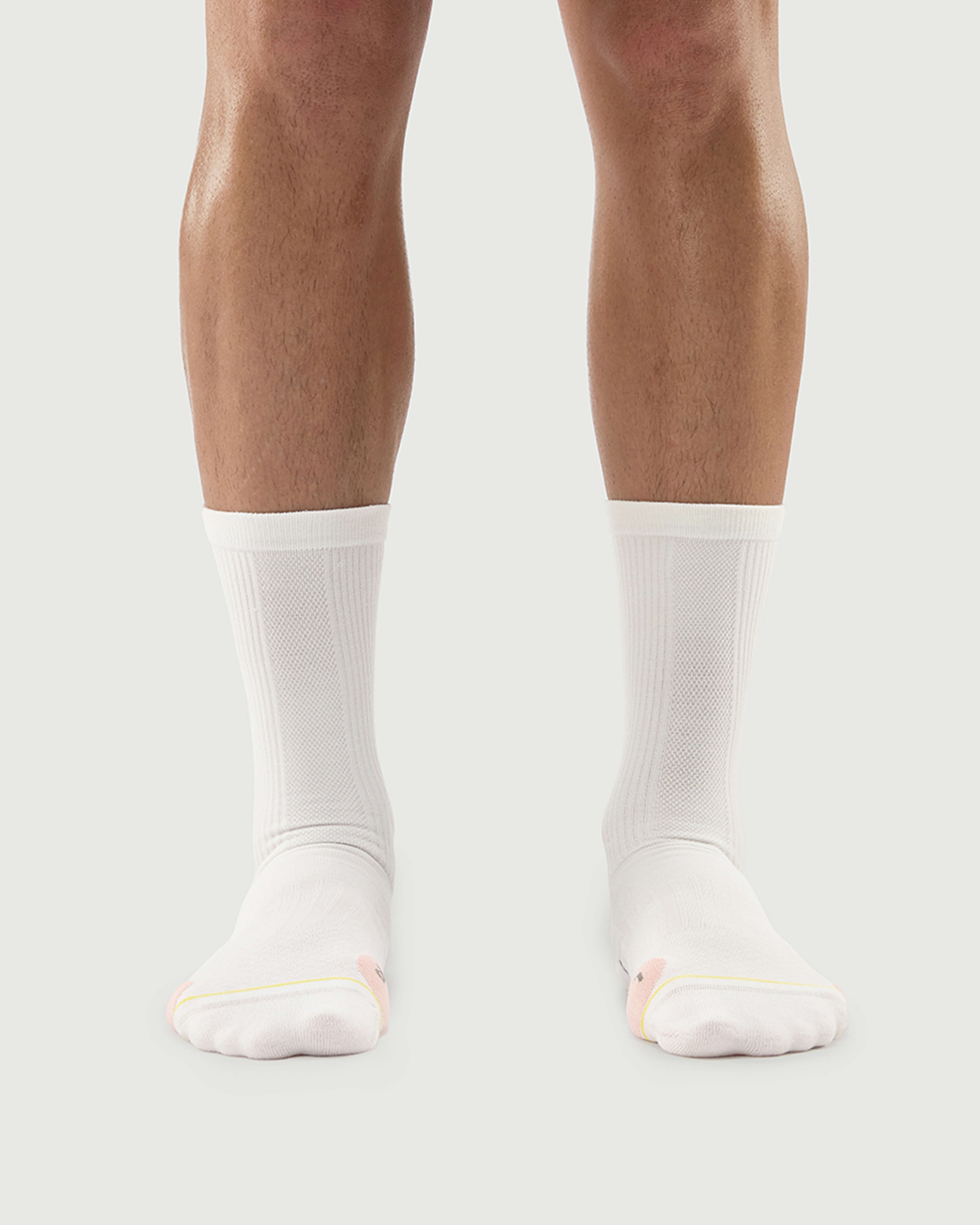 Front view of white Naughty Panda socks on a model, showcasing a clean minimalist style.