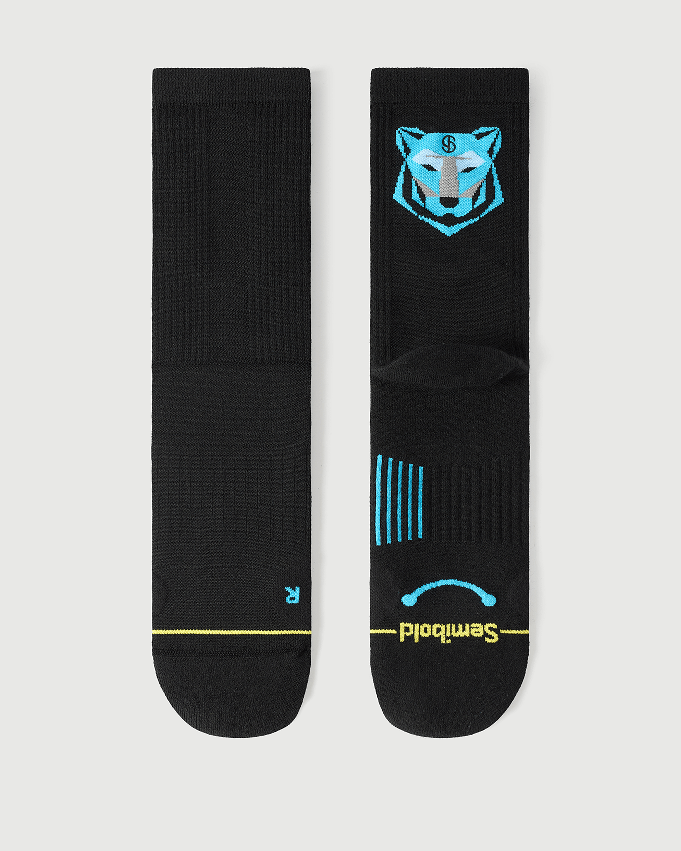 Flat lay of Semibold Regal Tiger black Merino socks with blue tiger face design on the back.