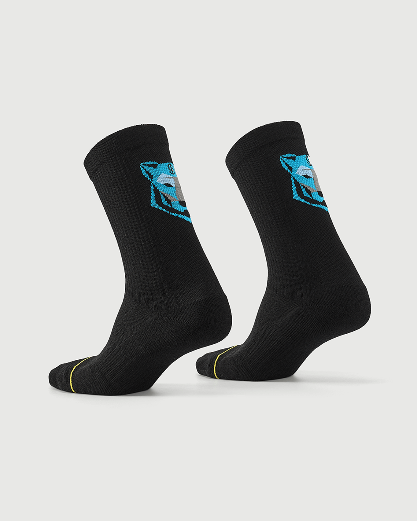 Black Regal Tiger socks on a foot form, highlighting the rear blue tiger graphic and side profile.