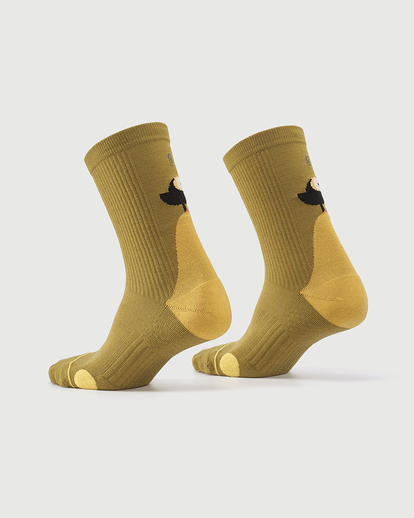 Yellow Royal Puffin socks on a foot form, displaying the side profile and puffin design.