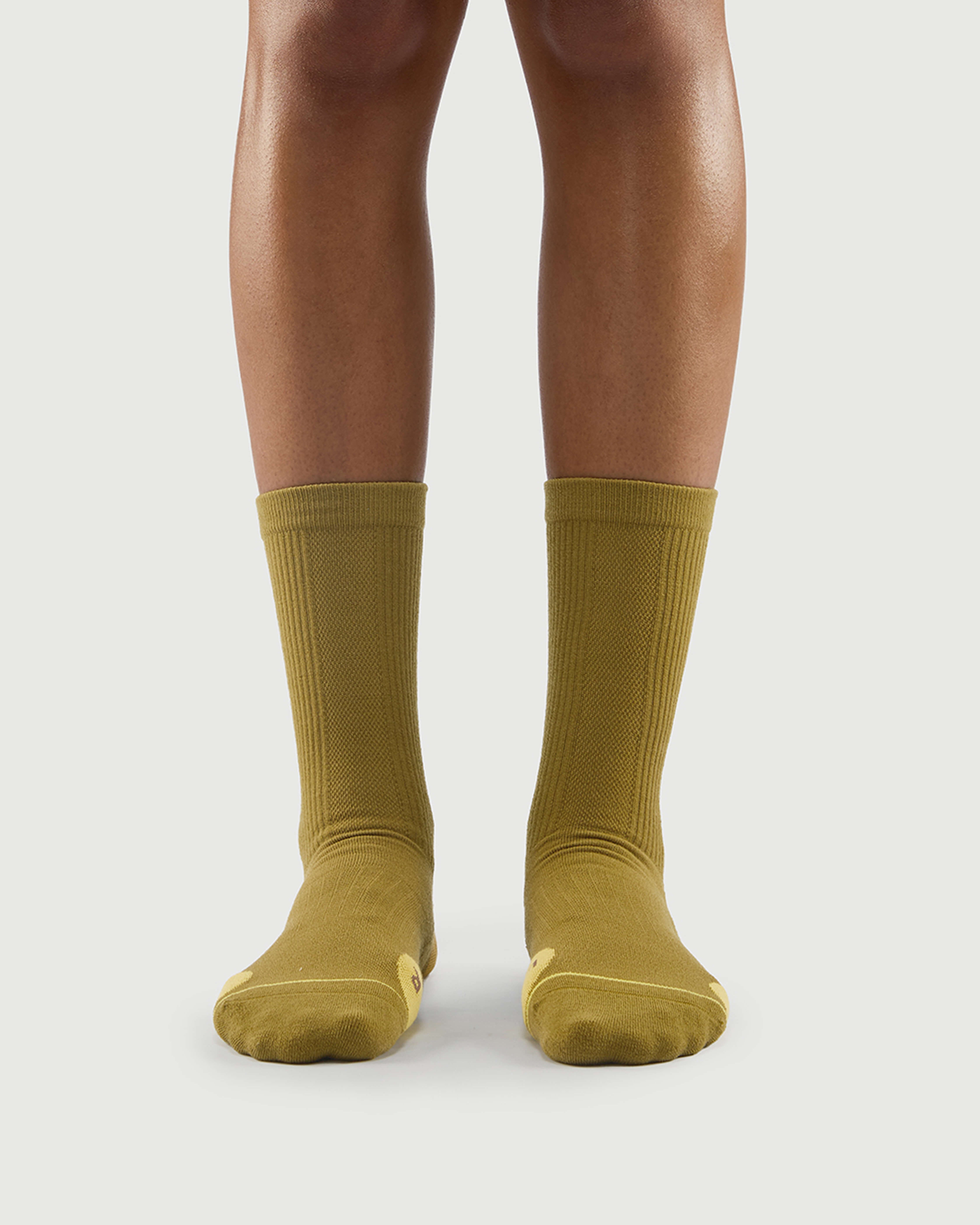 Front view of yellow Royal Puffin hiking socks on a model, bright and energetic design.