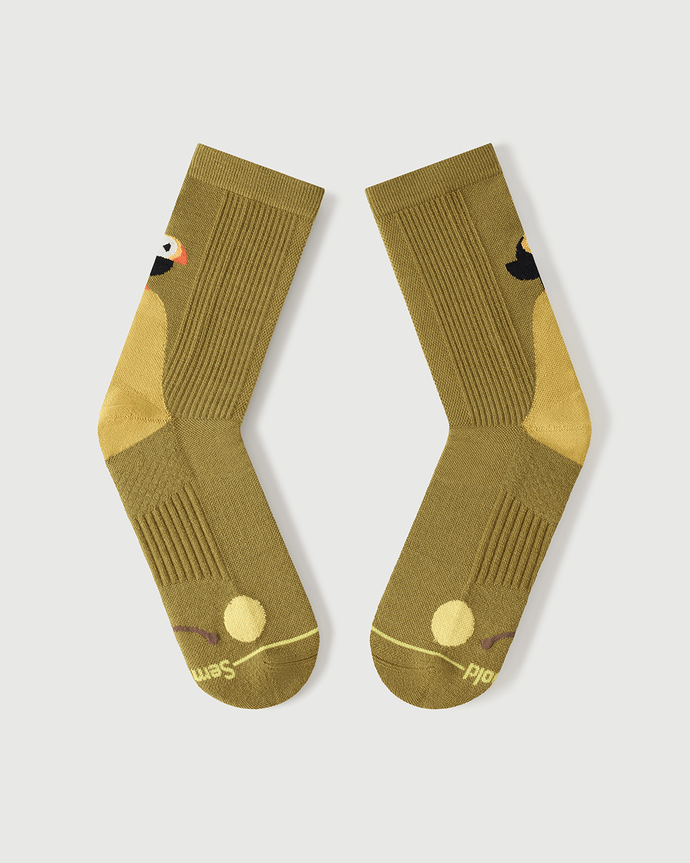 Flat lay view of the lateral side of yellow Royal Puffin socks, showing the outer toe cushioning.