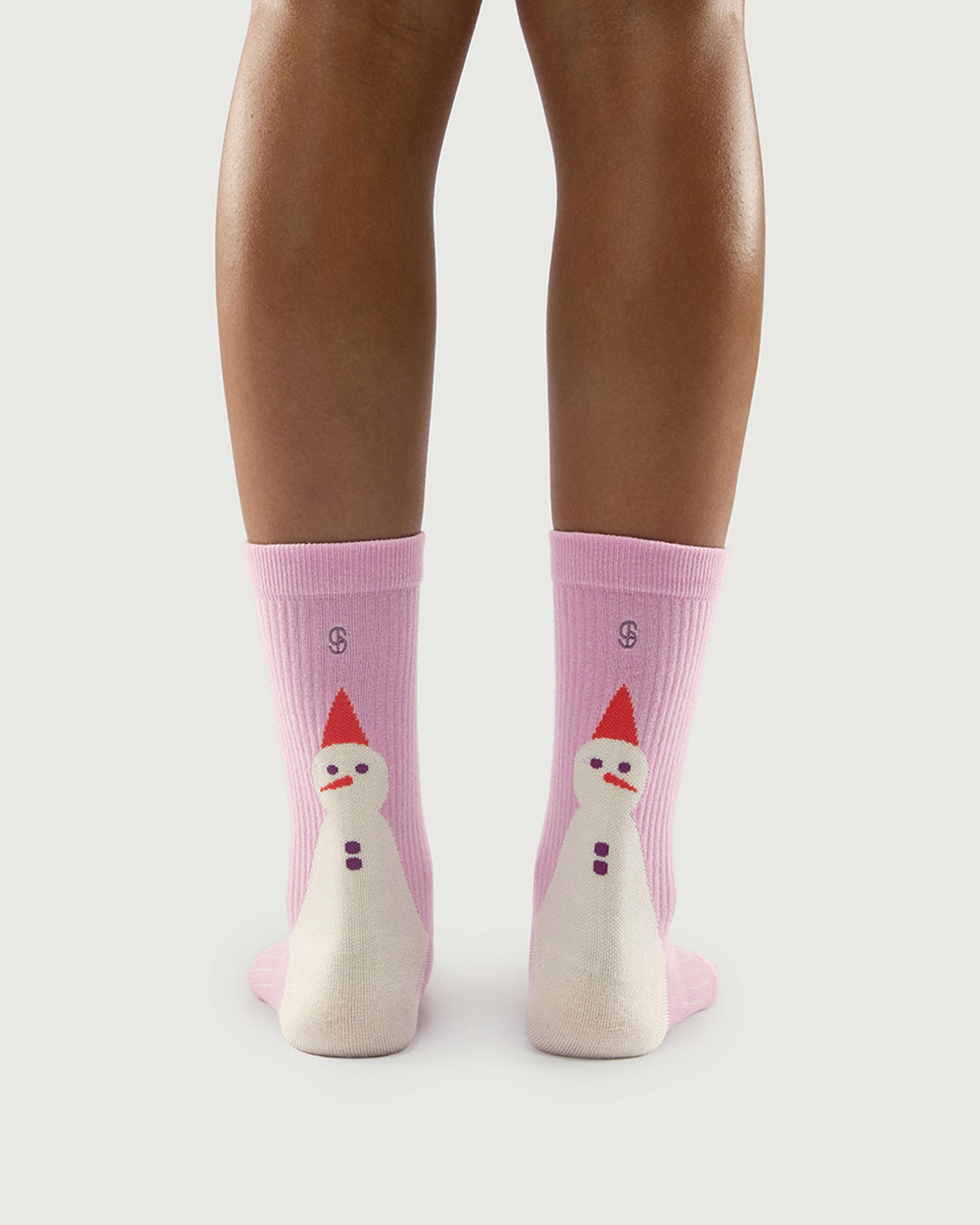 Back view of pink Sakura Snowman socks on a model, highlighting the cute snowman pattern.