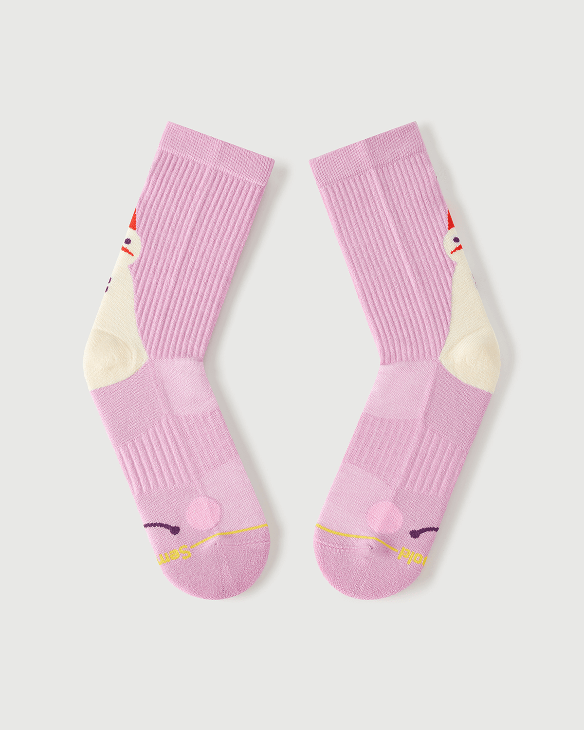 Flat lay view of the lateral side of pink Sakura Snowman Merino wool crew socks.