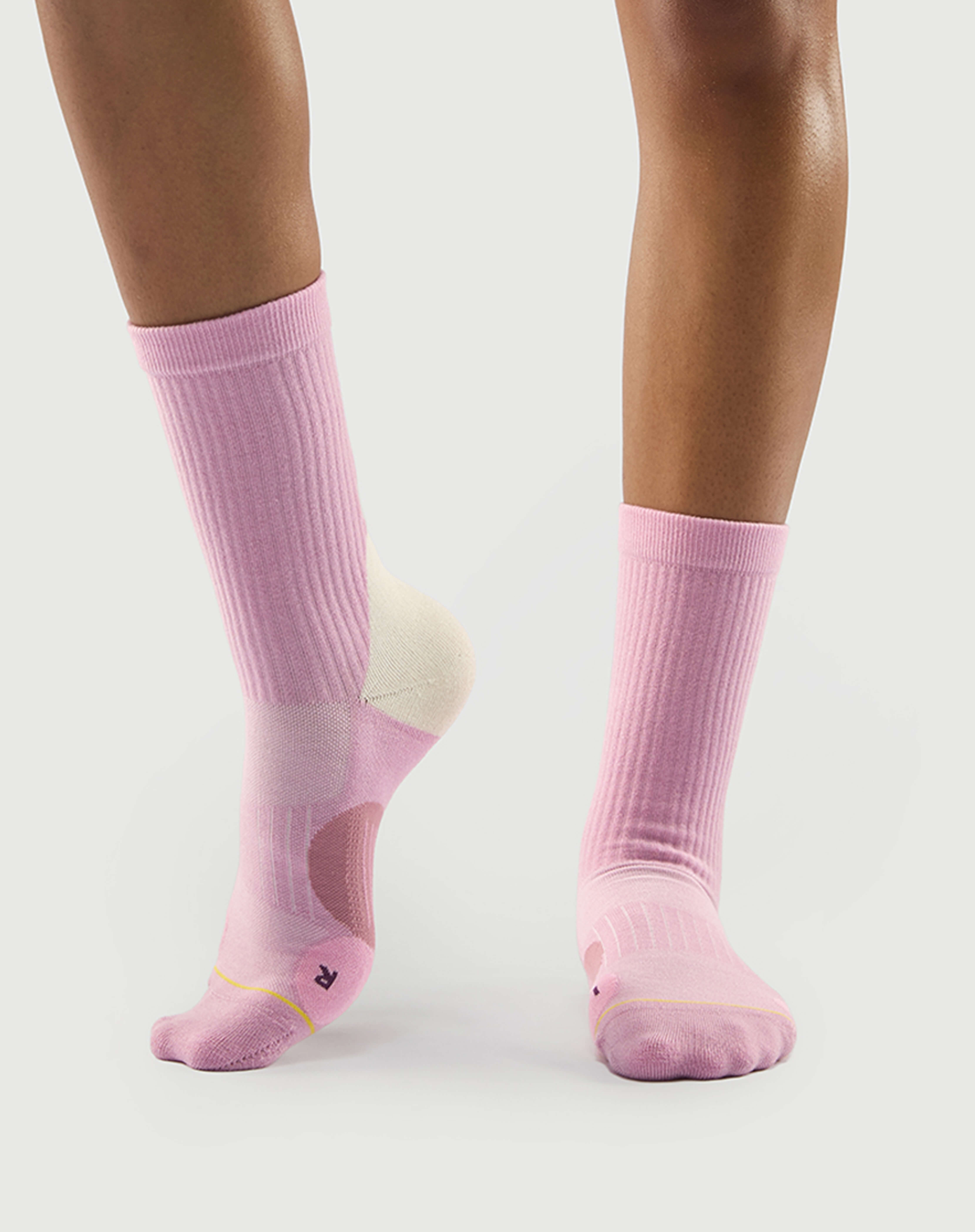Side profile of pink Sakura Snowman socks on a model, perfect for everyday or hiking wear.