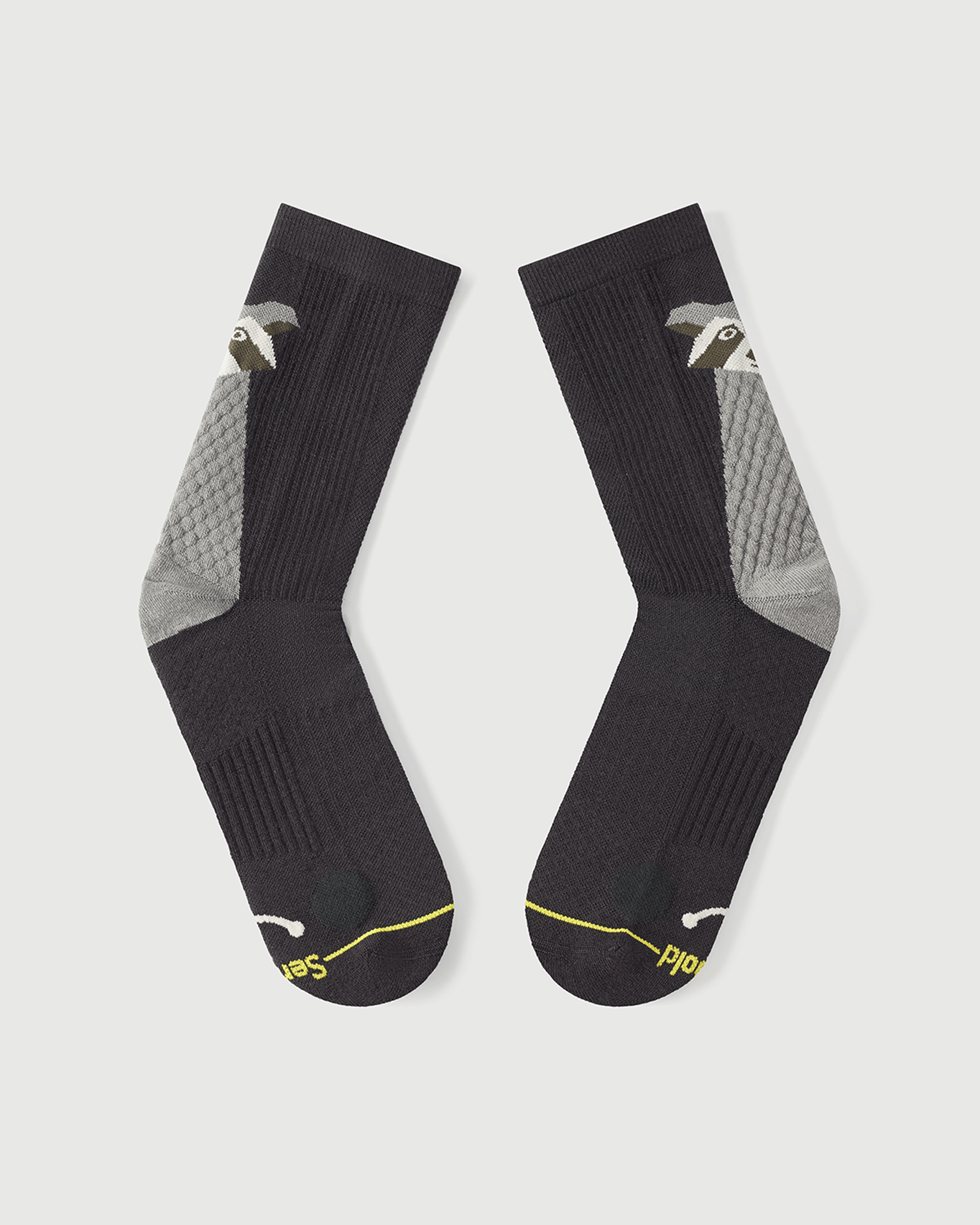 Flat lay view of the lateral side of Scrubby Raccoon grey Merino wool socks.