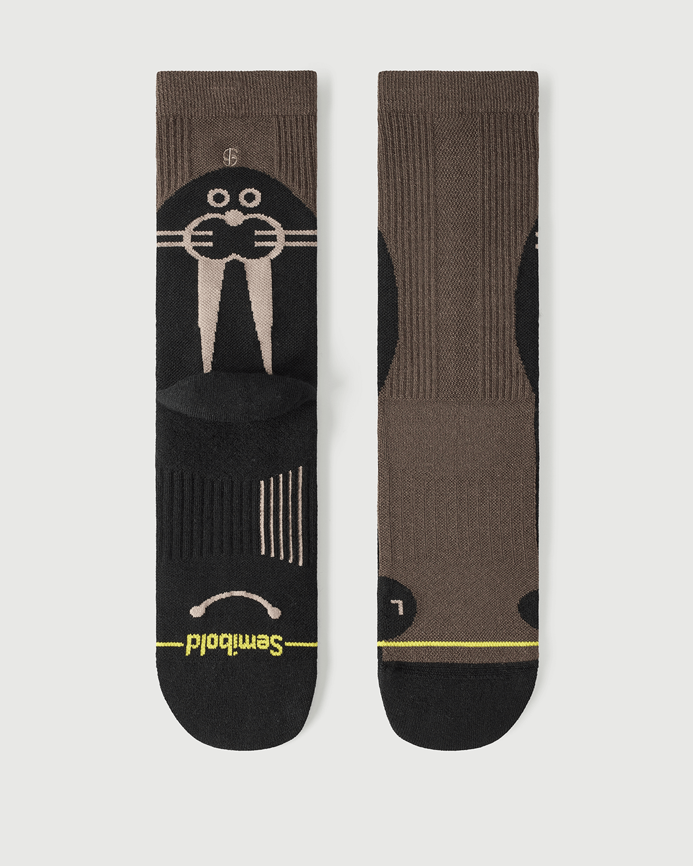 Flat lay of Semibold Whiz Walrus black and brown Merino socks showing a bold two-tone design.