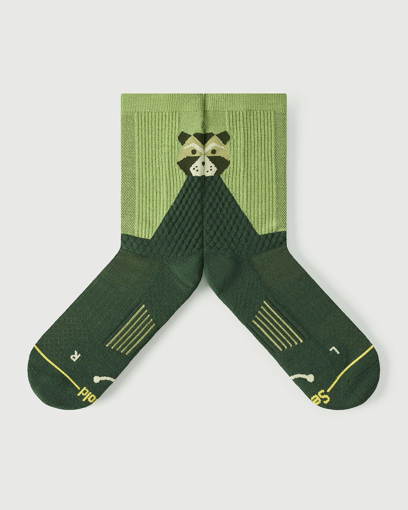 Flat lay view of green Crafty Otter socks focusing on the inner medial arch support structure.