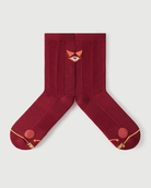 Detailed flat lay of red Devoted Fox socks highlighting the inner arch spine and compression zones.