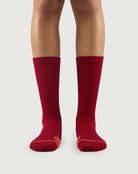 Front view of red Devoted Fox socks on a model, vibrant color for hiking and everyday wear.