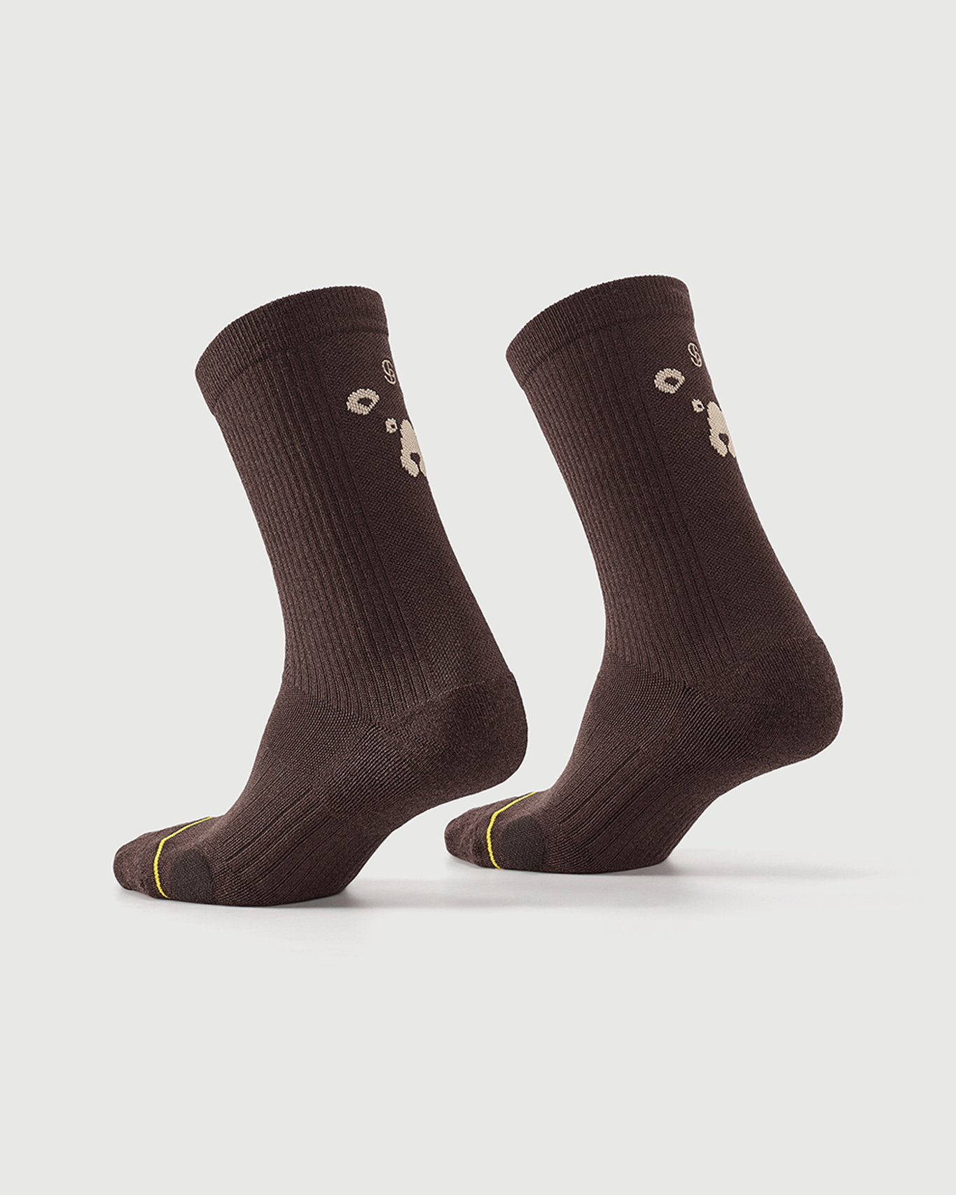 Brown Humble Bear socks displayed on a foot form, showing the back and side construction.