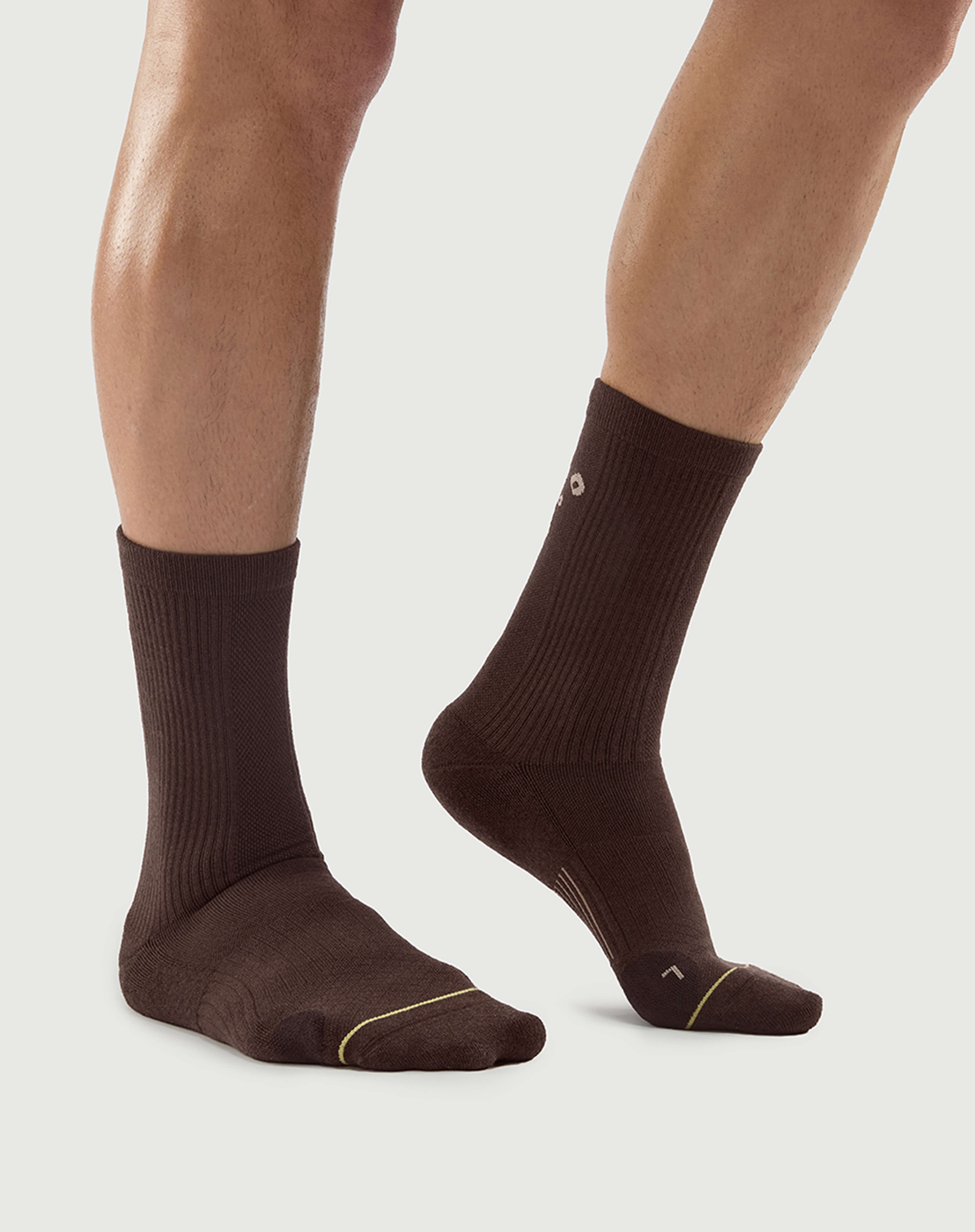 Side view of brown Semibold Humble Bear hiking socks on a model highlighting the sleek profile.