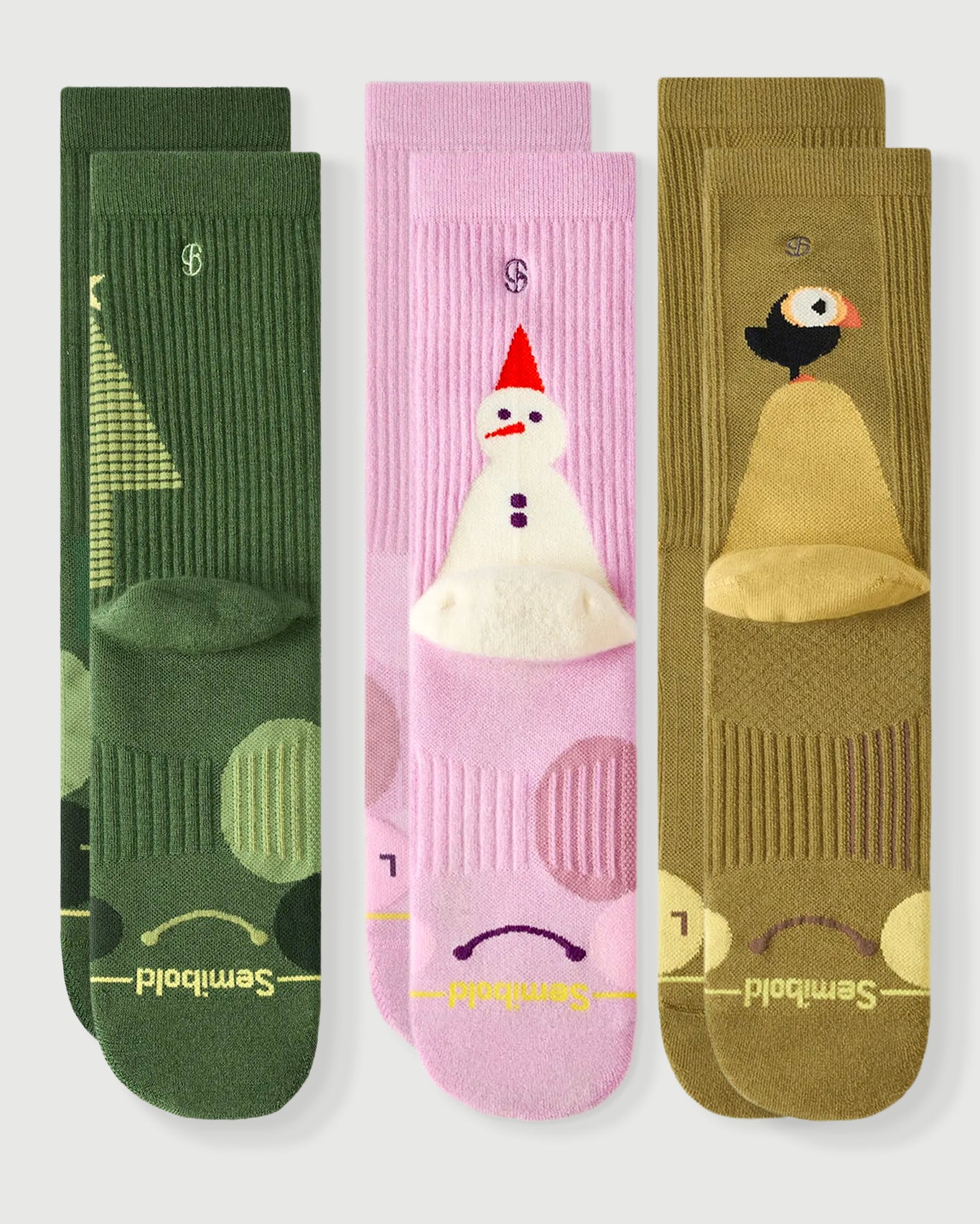 Semibold Merino Wool Hiking Crew Socks 3-Pack featuring Starry Pine, Sakura Snowman, and Royal Puffin designs. The image shows the front and back of each sock, highlighting the playful character patterns and technical cushioning.