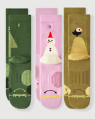 Semibold Merino Wool Hiking Crew Socks 3-Pack featuring Starry Pine, Sakura Snowman, and Royal Puffin designs. The image shows the front and back of each sock, highlighting the playful character patterns and technical cushioning.