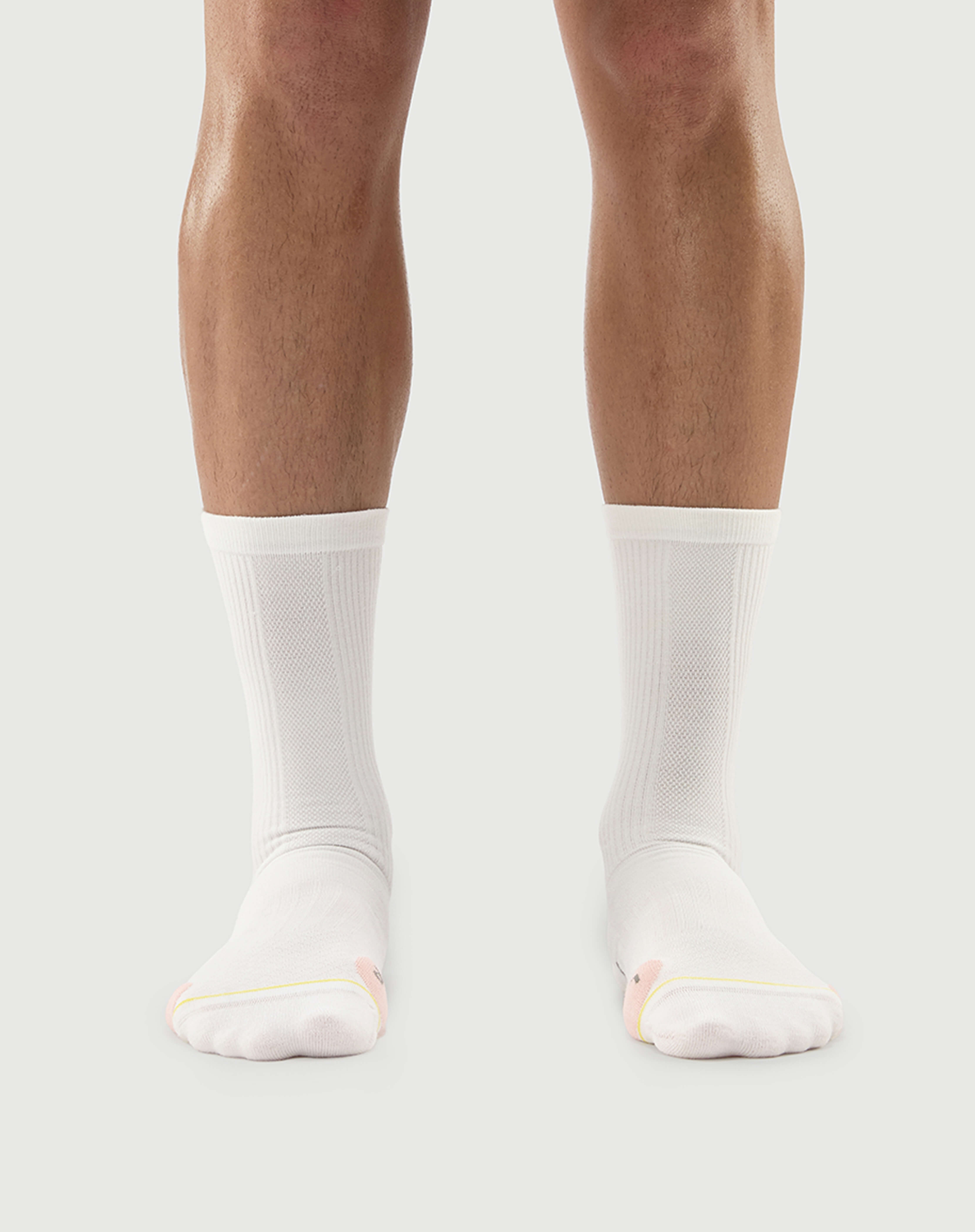 Front view of white Naughty Panda socks on a model, showcasing a clean minimalist style.