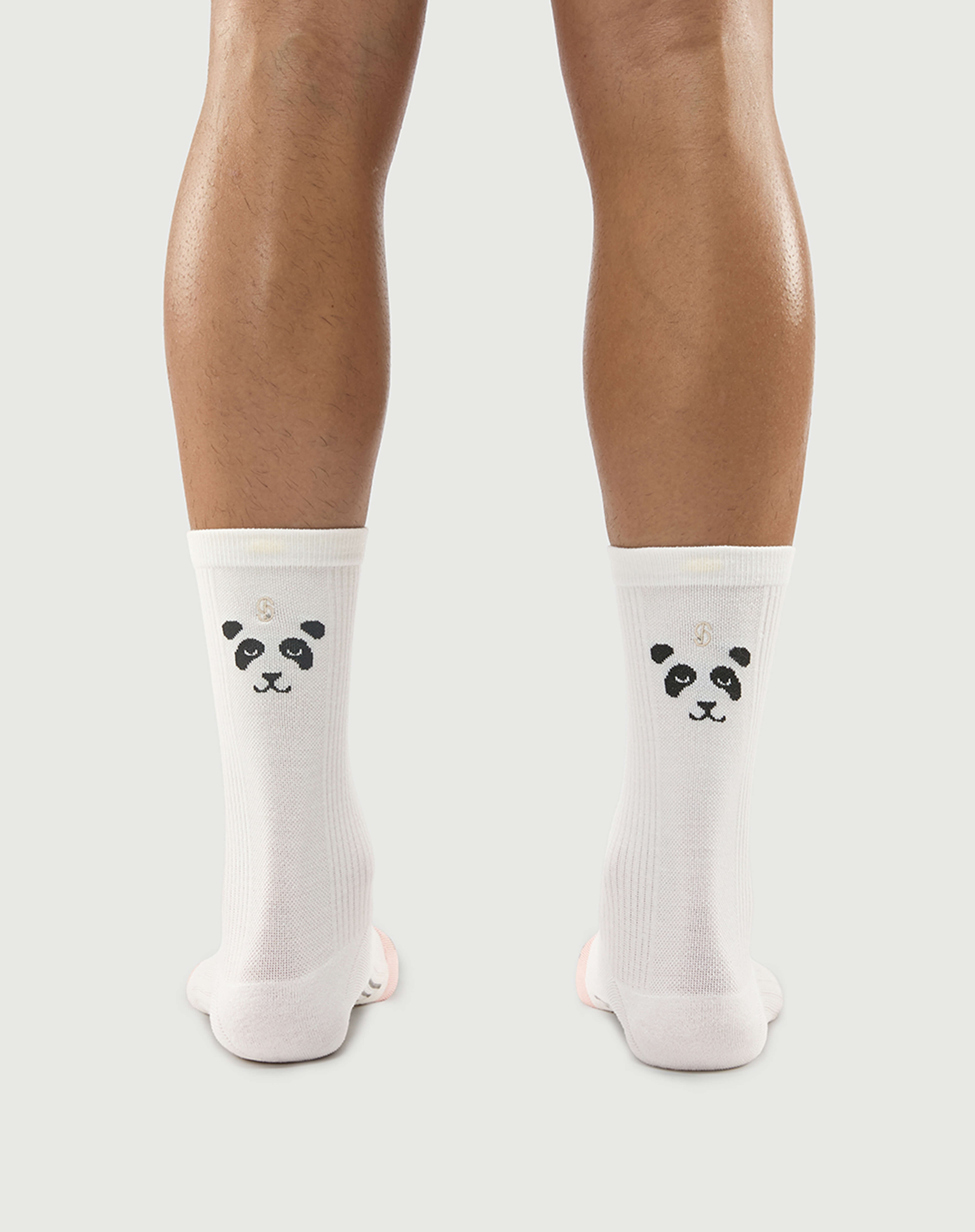 Model wearing white Naughty Panda socks, featuring the panda face design on the back.