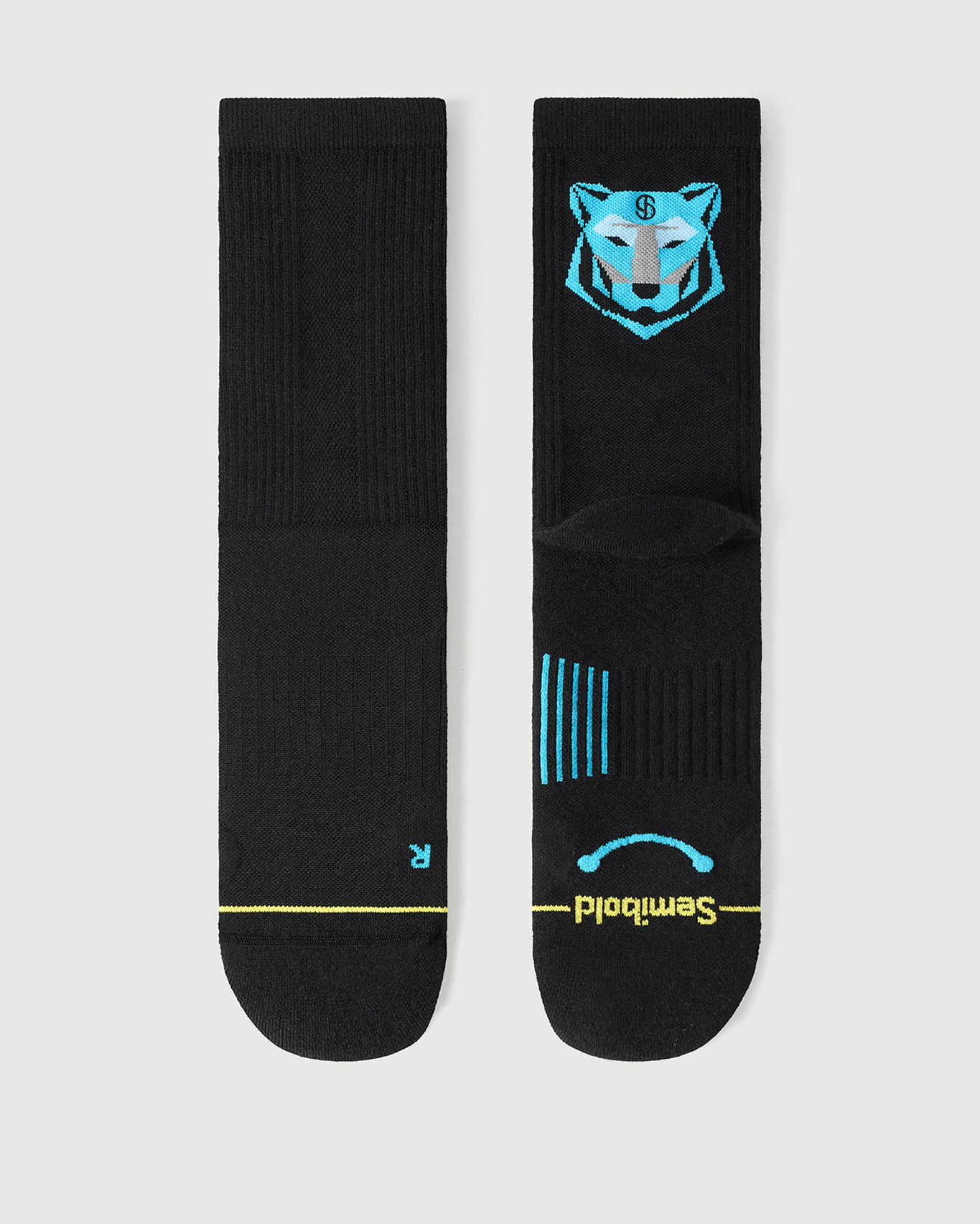 Flat lay of Semibold Regal Tiger black Merino socks with blue tiger face design on the back.