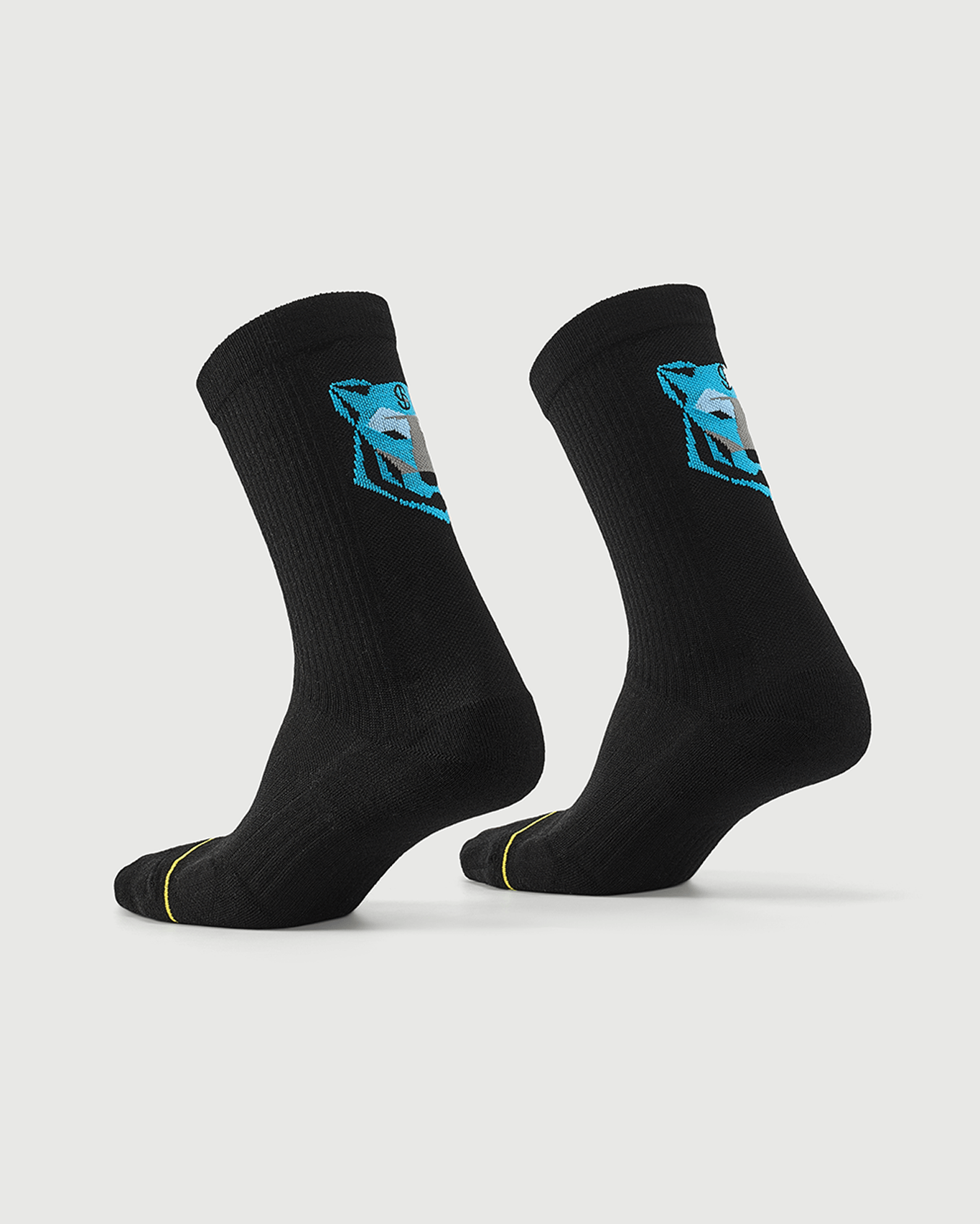 Black Regal Tiger socks on a foot form, highlighting the rear blue tiger graphic and side profile.