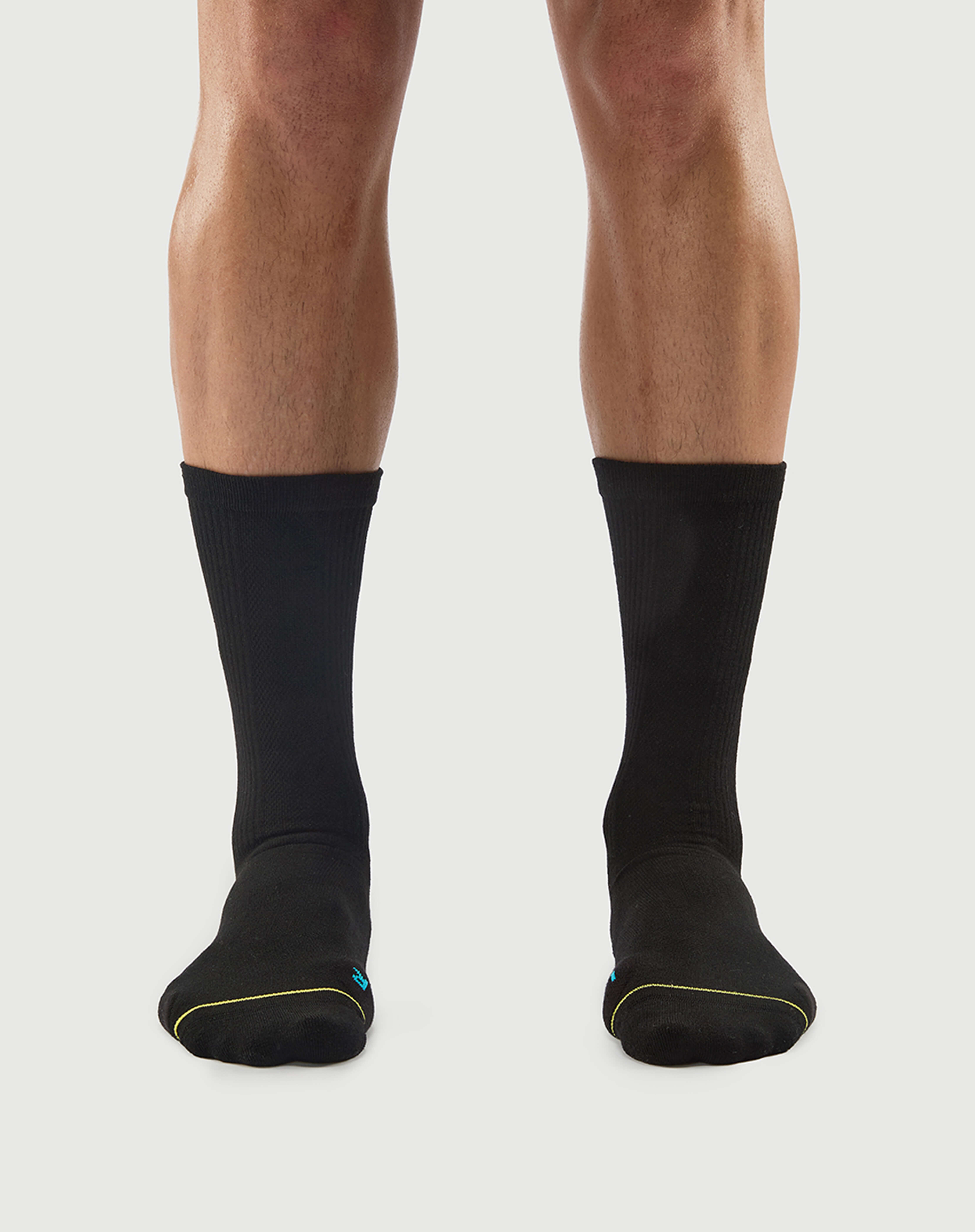 Front view of black Regal Tiger socks on a model, showing a classic minimalist look.