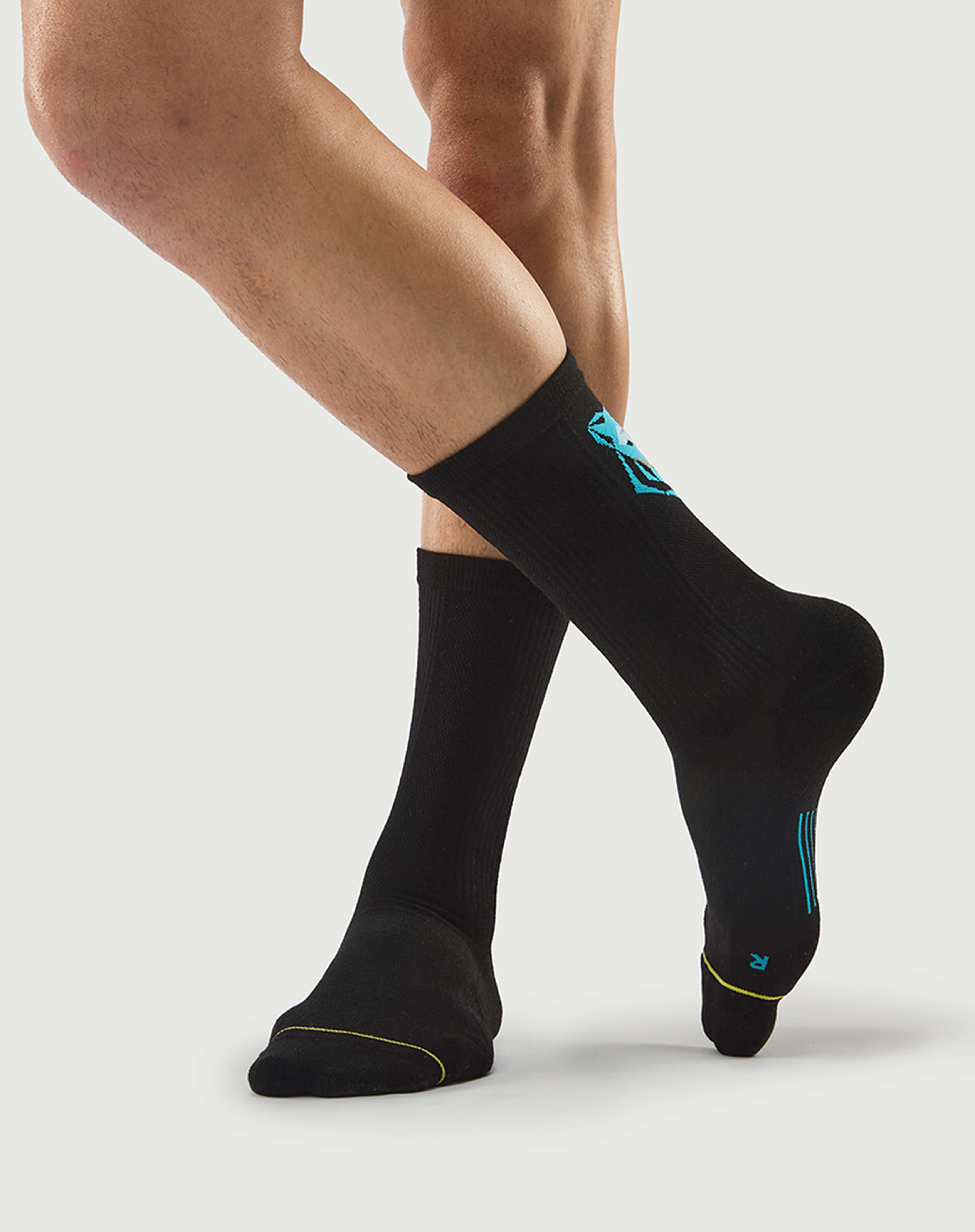 Side view of black Regal Tiger hiking socks on a model, showing the technical knit texture.