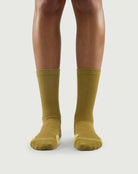 Front view of yellow Royal Puffin hiking socks on a model, bright and energetic design.