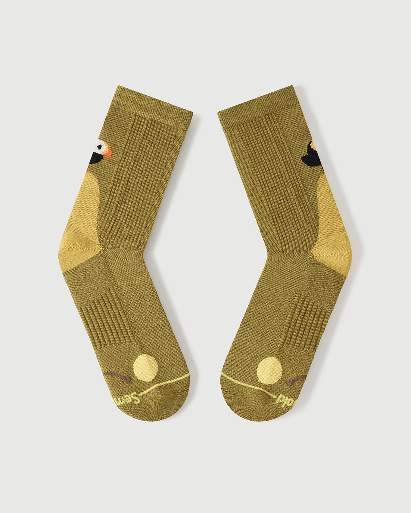 Flat lay view of the lateral side of yellow Royal Puffin socks, showing the outer toe cushioning.