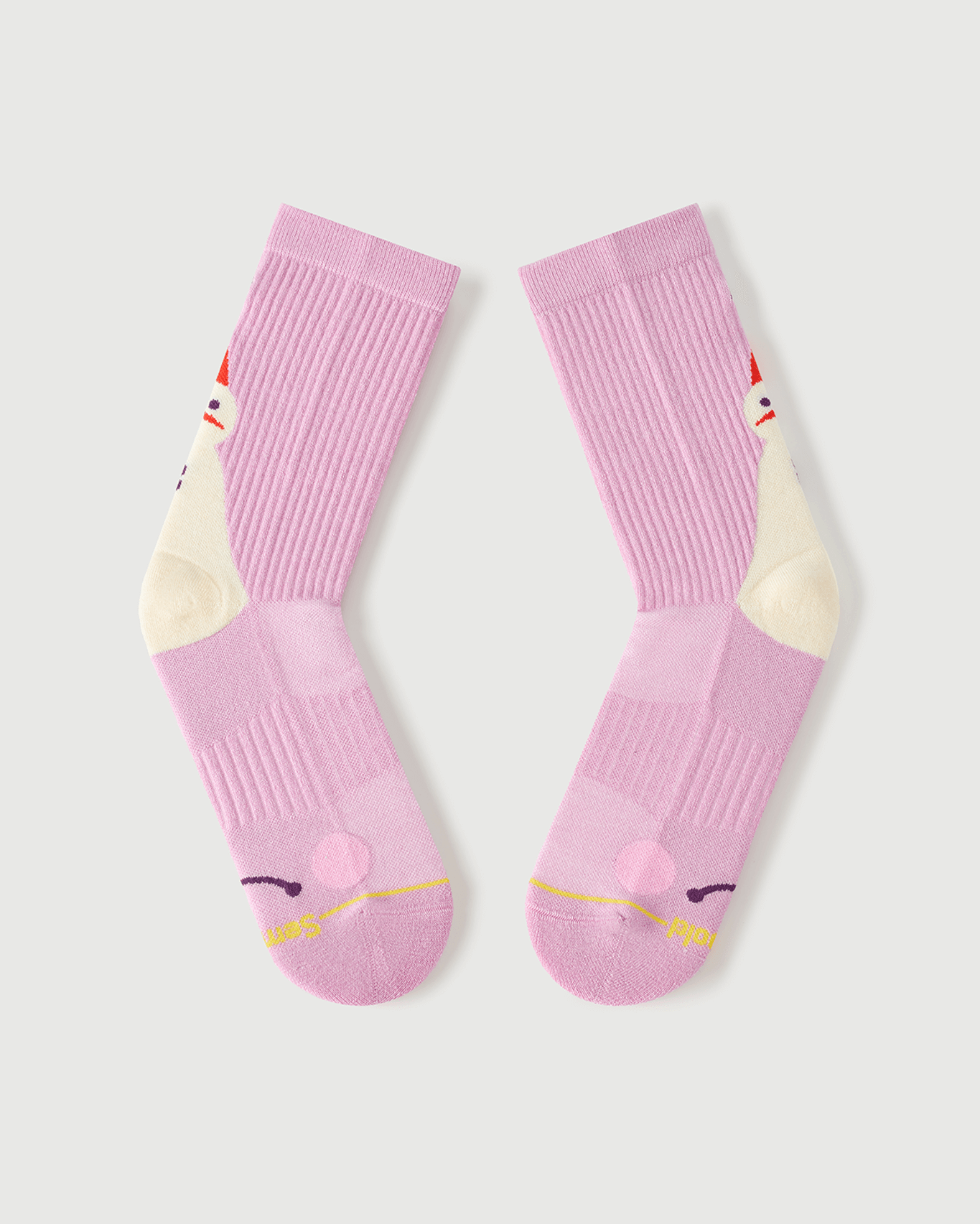 Flat lay view of the lateral side of pink Sakura Snowman Merino wool crew socks.