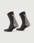 Grey Scrubby Raccoon socks on a foot form, displaying the side and rear character design.