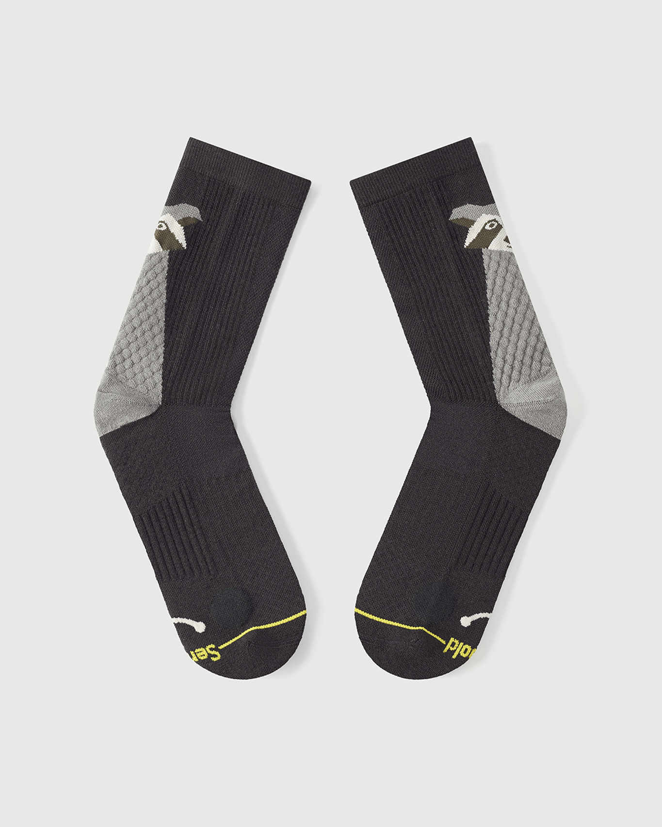 Flat lay view of the lateral side of Scrubby Raccoon grey Merino wool socks.