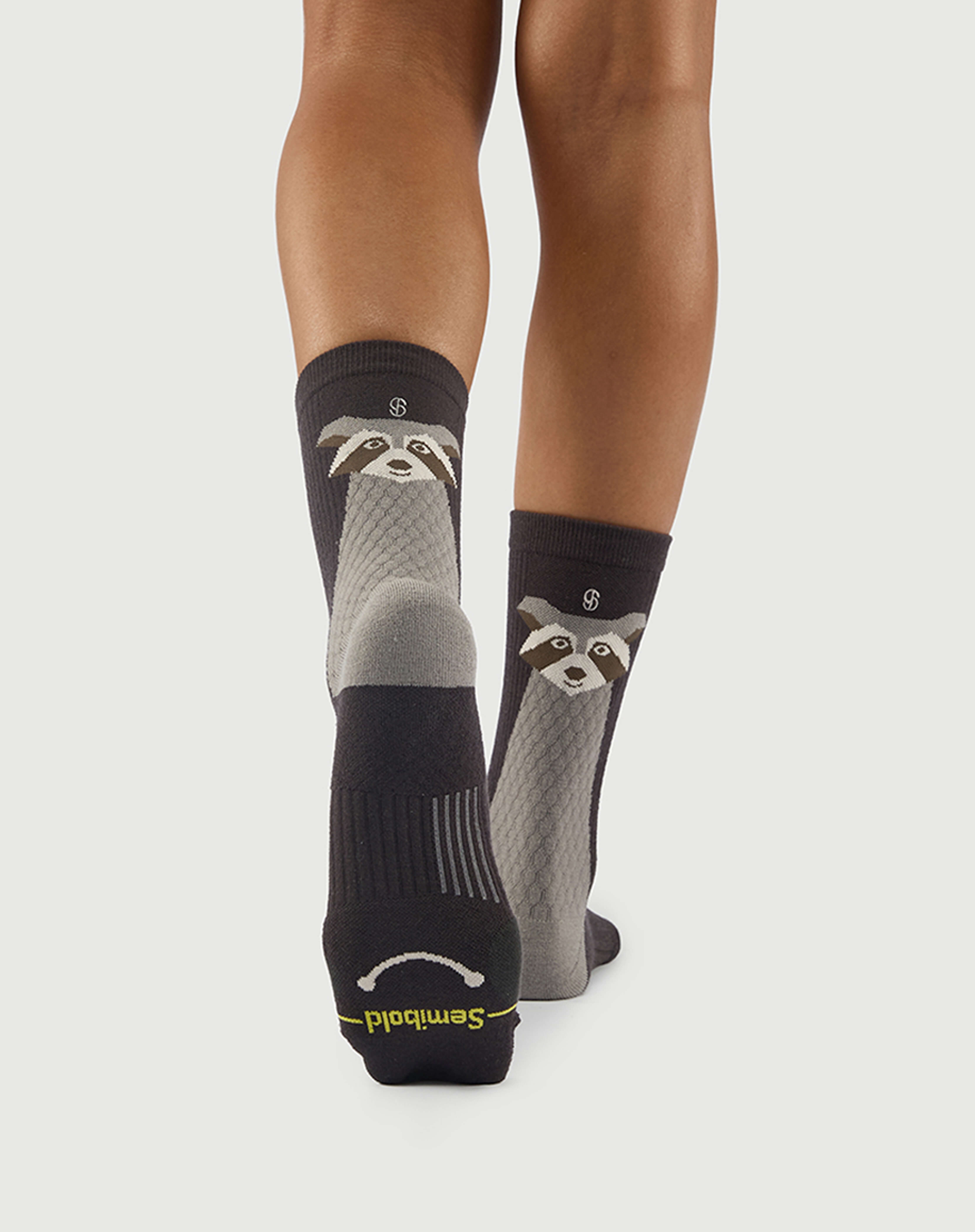 Sole view of Scrubby Raccoon socks on a model, showing the performance arch support knit.