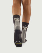 Sole view of Scrubby Raccoon socks on a model, showing the performance arch support knit.