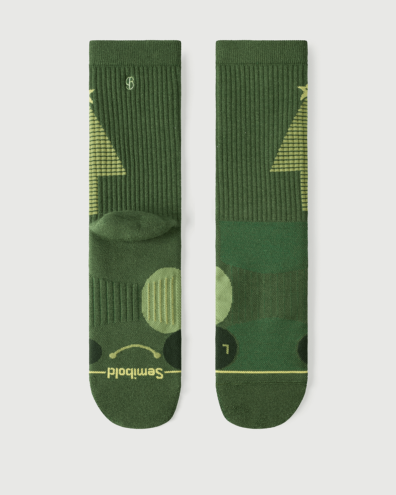 A pair of Starry Pine Merino wool hiking crew socks displayed flat, showing the front with a signature smile and the back with a yellow Christmas tree design.