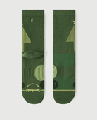 A pair of Starry Pine Merino wool hiking crew socks displayed flat, showing the front with a signature smile and the back with a yellow Christmas tree design.