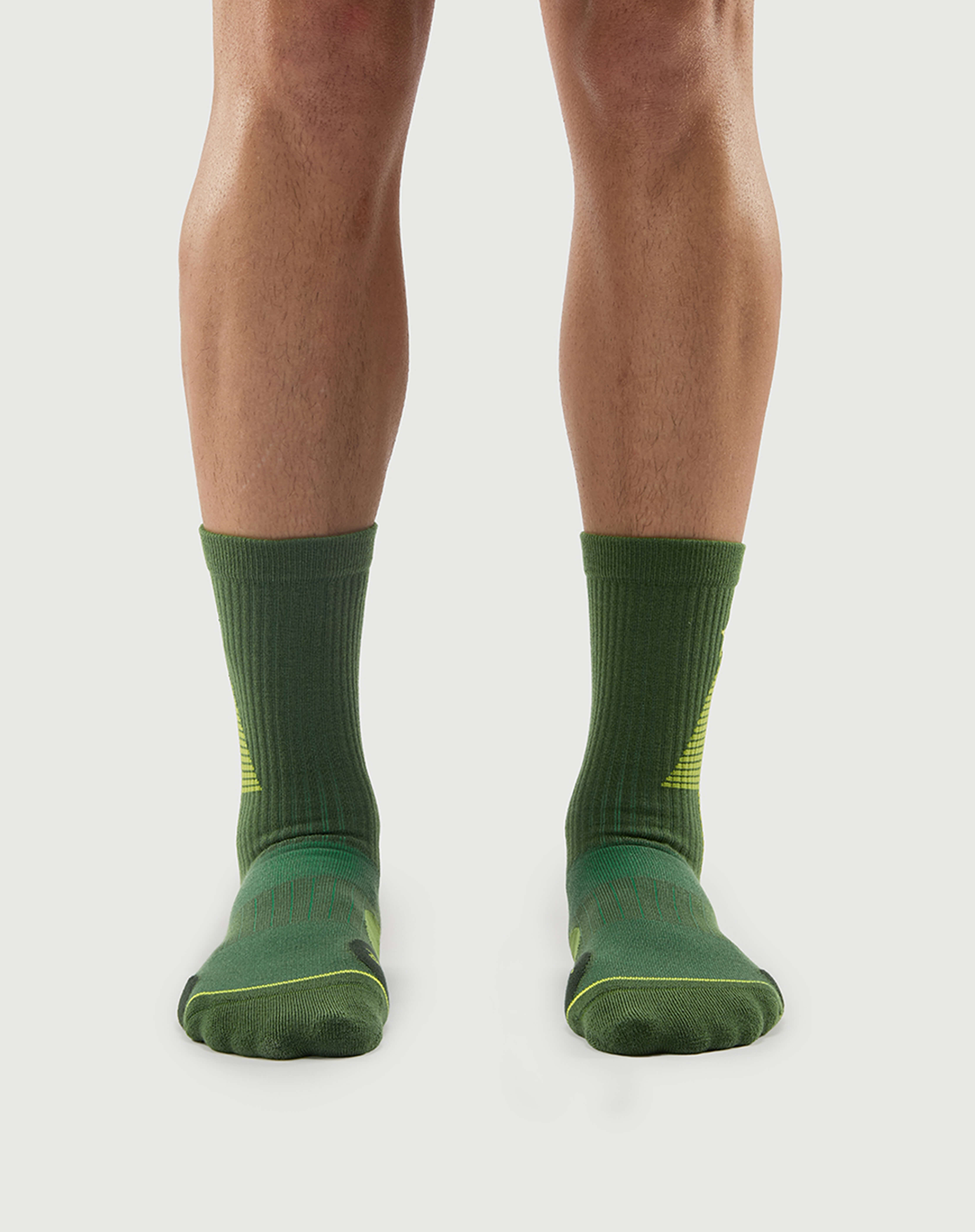 Front view of a model wearing Starry Pine Merino wool hiking crew socks, showcasing the secure ribbed fit and high-performance knit.