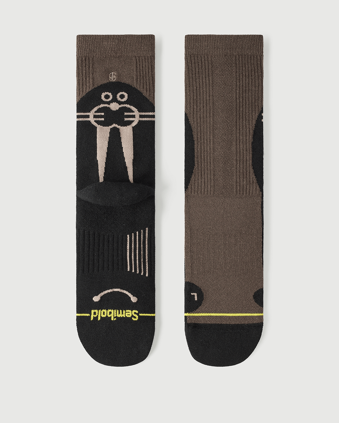 Flat lay of Semibold Whiz Walrus black and brown Merino socks showing a bold two-tone design.