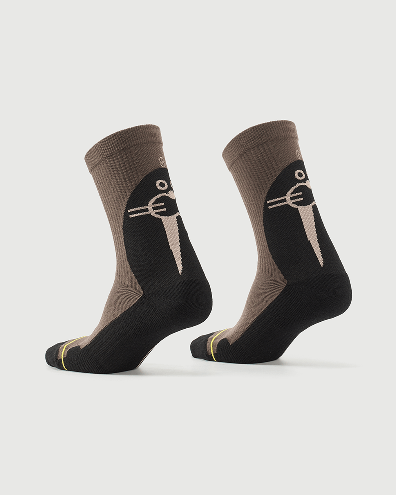 Whiz Walrus black and brown socks on a foot form, showing the character pattern on the heel.