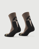 Whiz Walrus black and brown socks on a foot form, showing the character pattern on the heel.