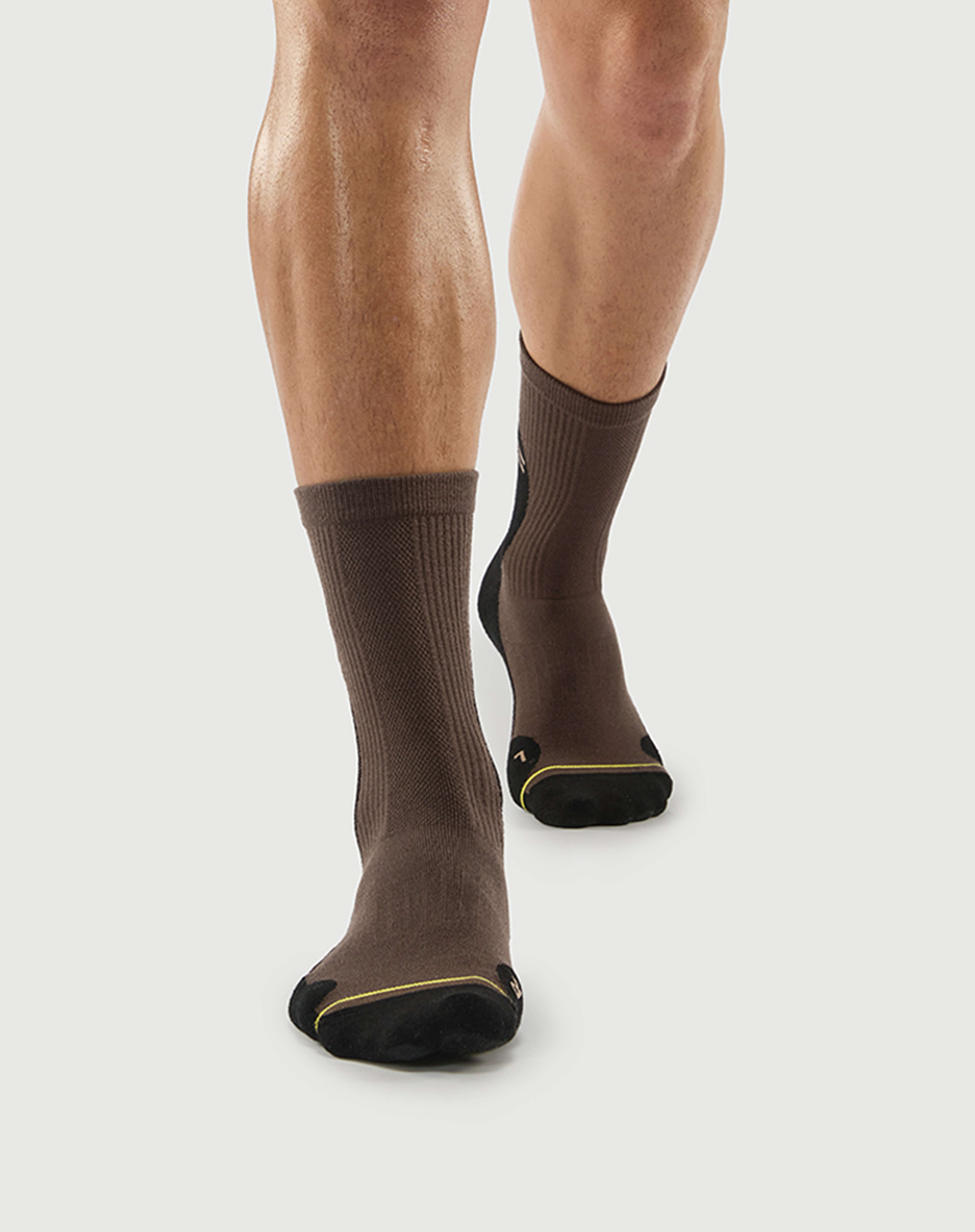 Front view of black and brown Whiz Walrus socks on a model, showing a unique aesthetic.