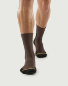 Front view of black and brown Whiz Walrus socks on a model, showing a unique aesthetic.