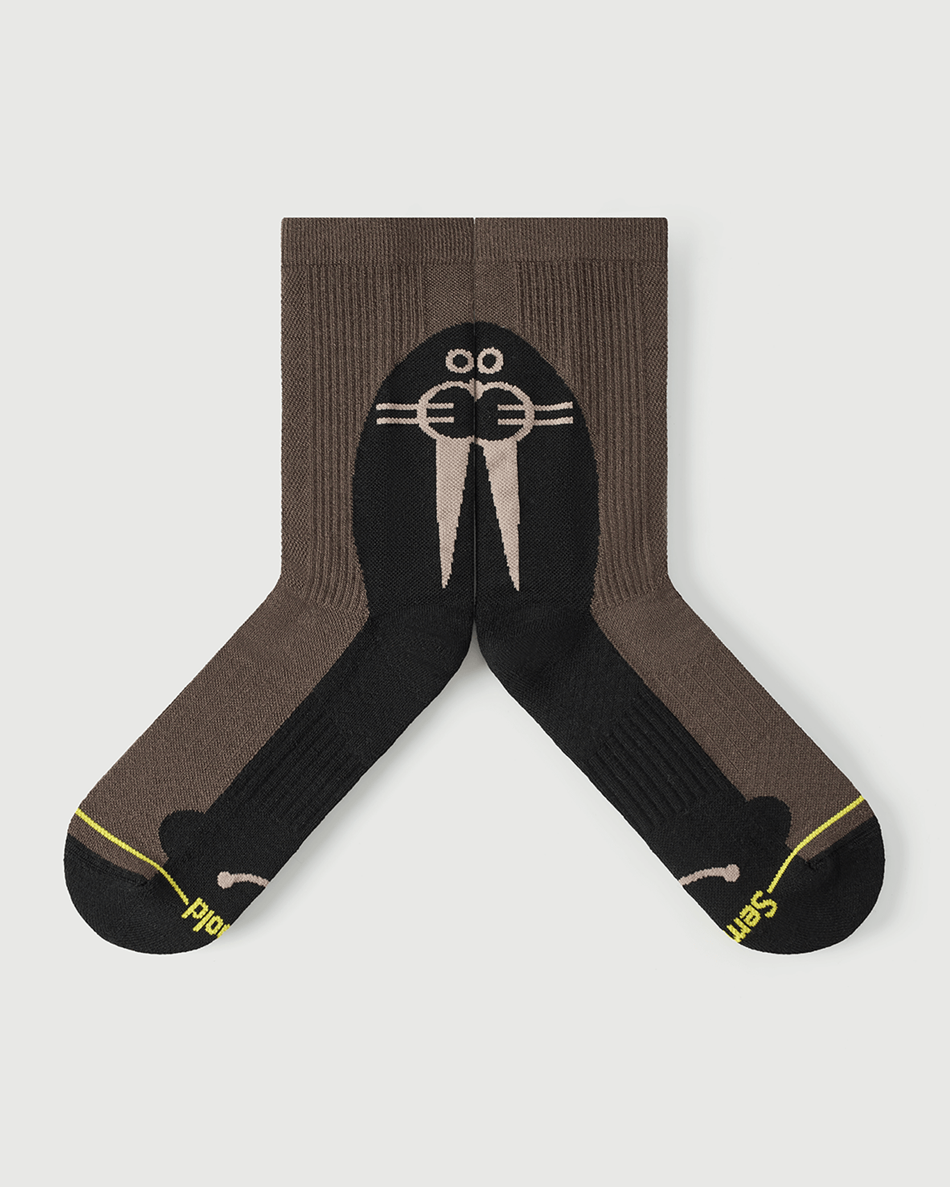 Flat lay view of the lateral side of Whiz Walrus black and brown Merino wool socks.